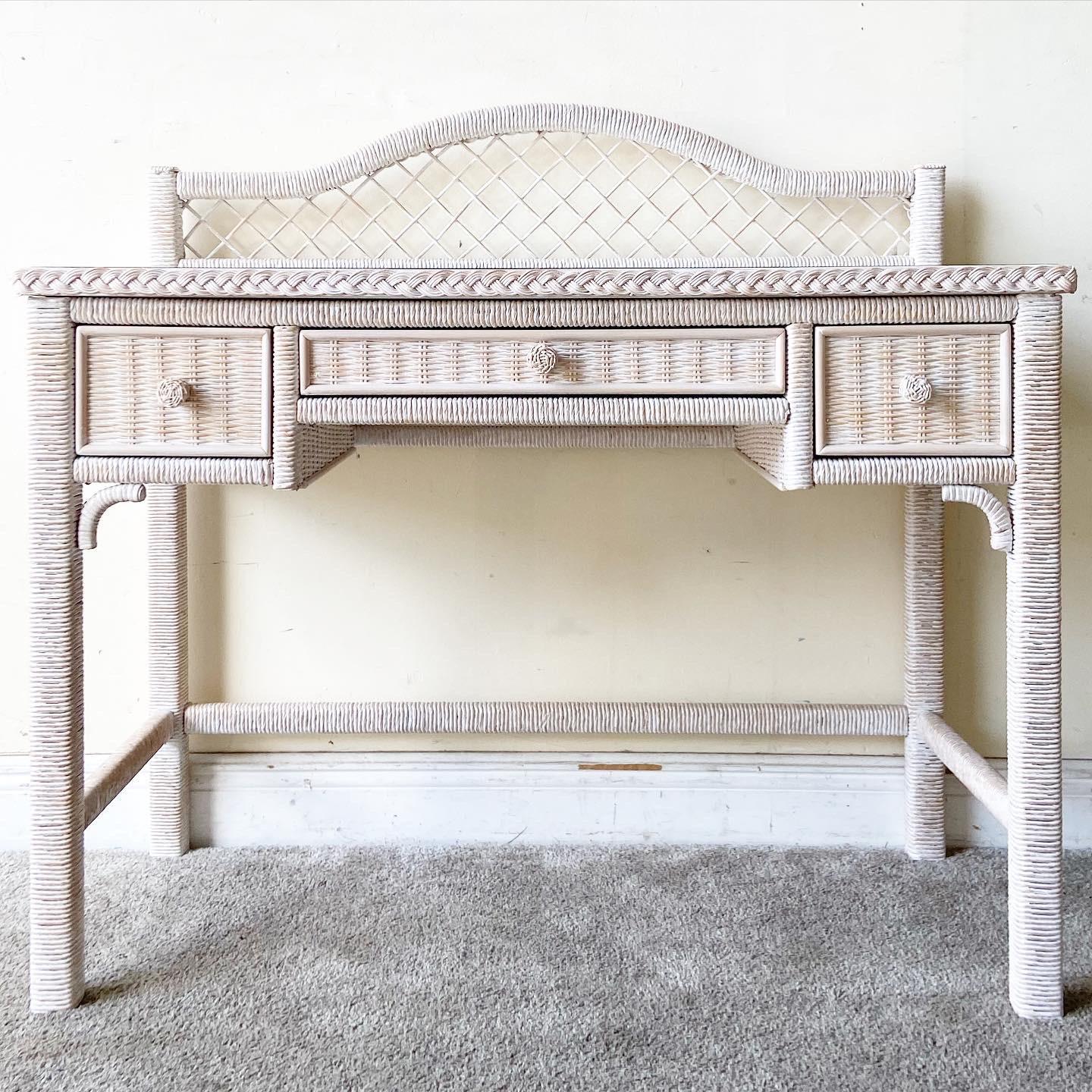 Exceptional wicker writing desk by Henry Link Furniture Co. Features a glass top and a rattan frame with a whitewash finish.