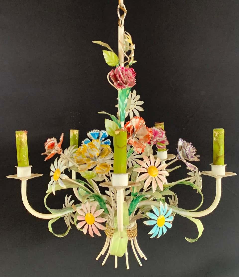 A stylish boho chic Italian tole metal flower chandelier. The hand tooled chandelier features multi-color flowers and roses in a form of a beautifully arranged bouquet , all hand painted in pastel cheerful spring colors. The chandelier has 5 arms