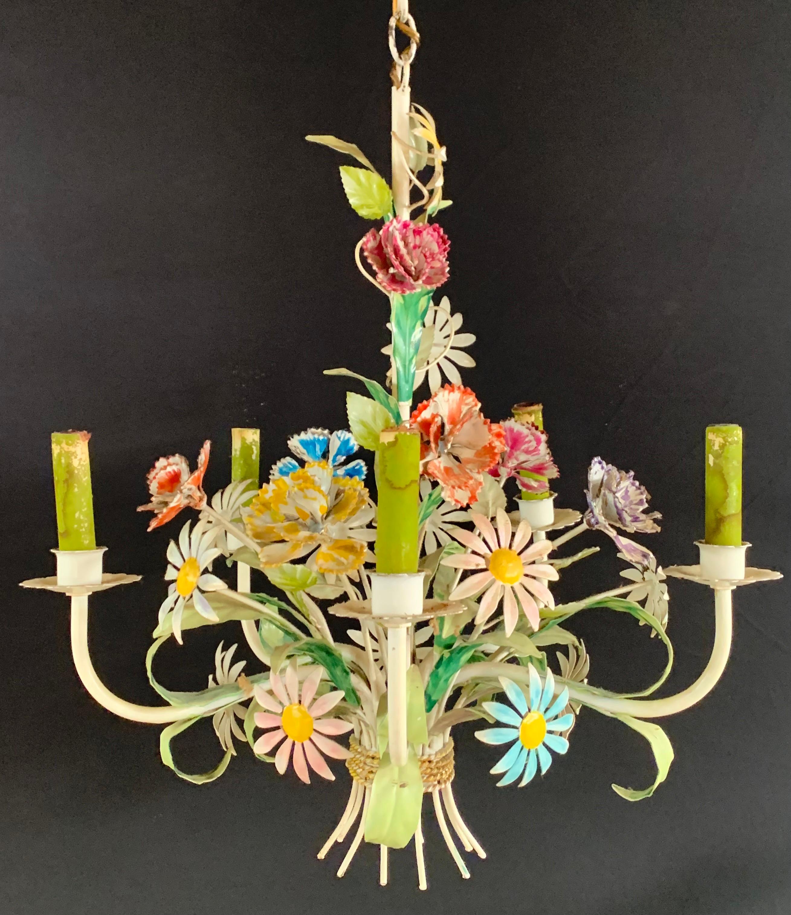A stylish boho chic Italian tole metal flower chandelier. The hand tooled chandelier features multi-color flowers and roses in a form of a beautifully arranged bouquet , all hand painted in pastel cheerful spring colors. The chandelier has 4 arms