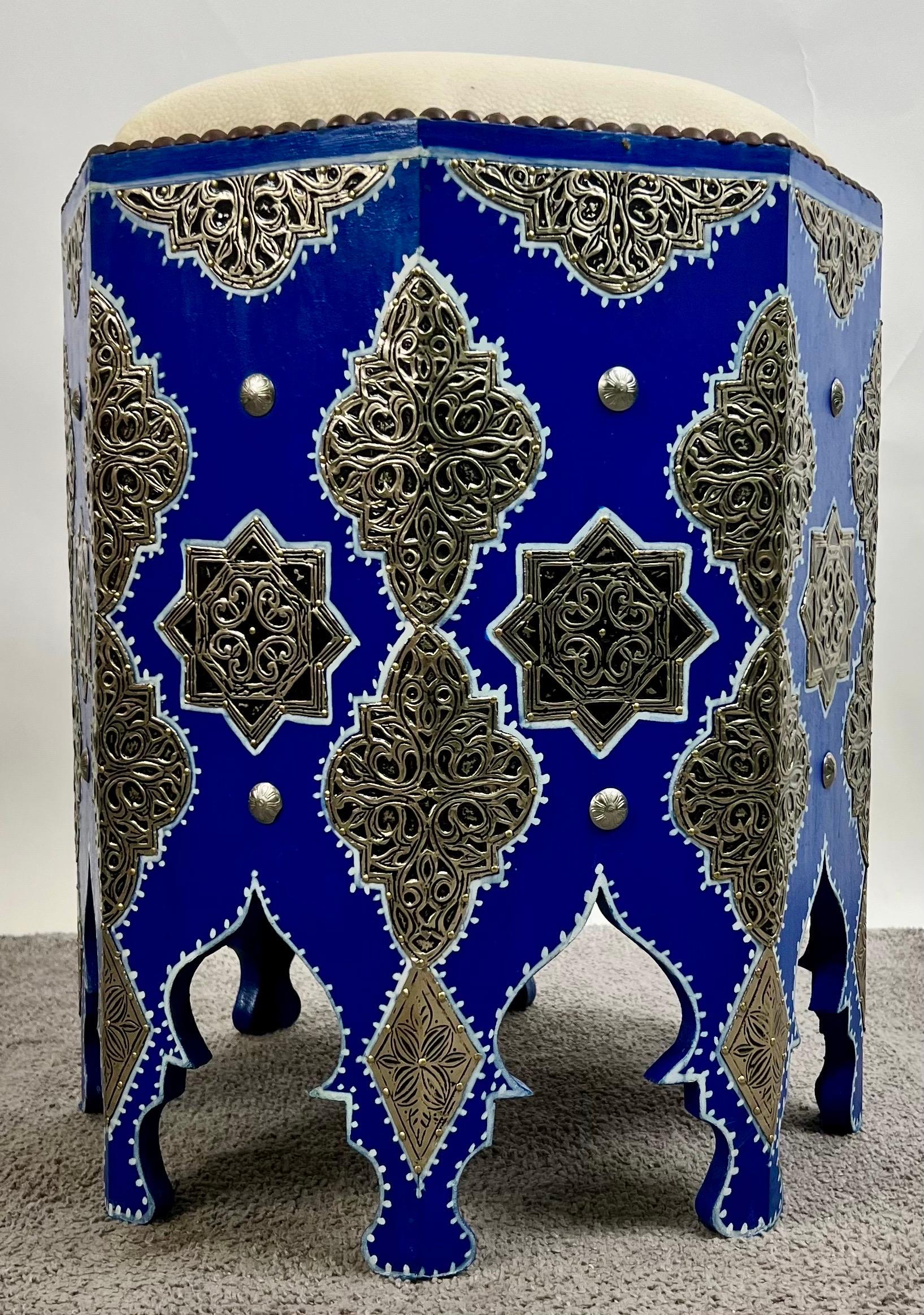 Boho Chic Moroccan Blue & Filigree Silver Design with White Leather Top Stool 

Infused with Moroccan artistry and Boho Chic flair, this striking stool is both functional and decorative. The hexagonal base is hand-finished in a rich cobalt blue,