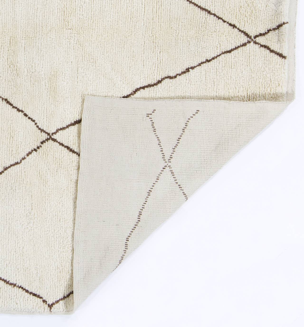 A modern handmade Moroccan rug, made of natural undyed ivory and brown wool. Soft, comfy, cozy pile.
It is available in 9 x 12 Ft (275 x 365 cm), 6 x 9 Ft (182 x 274 cm) and 3.2 x 6 Ft (95 x 180 cm) for immediate dispatch.

The rug can be custom