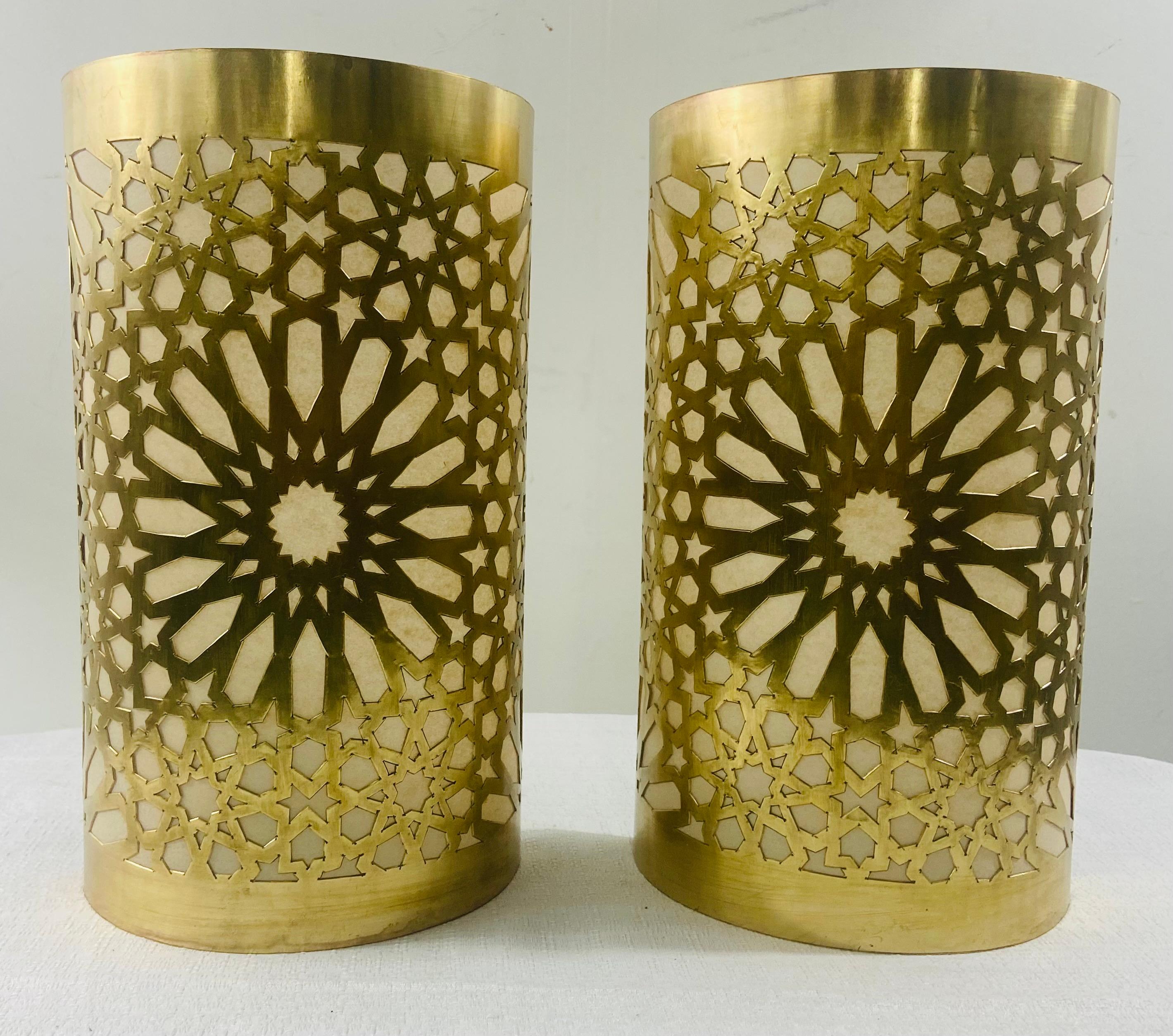 A stylish pair of Boho Chic Moroccan style sconces or wall lanterns. The wall sconces are finely handmade of high quality brass featuring a large floral design in the center and geometrical motifs enabling the creation of a cozy and fun lighting