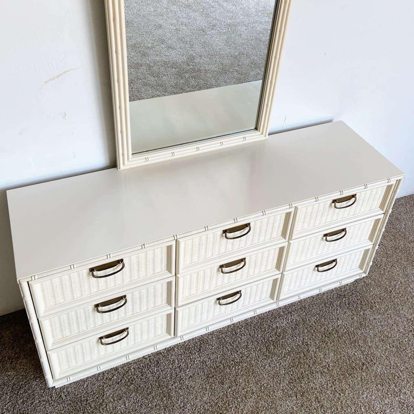 Incredible vintage bohemian faux bamboo dresser with matching mirror. Features faux wicker drawer faces with an off white finish.

Mirror measures 28”W, 1.5”D, 47.5”H
