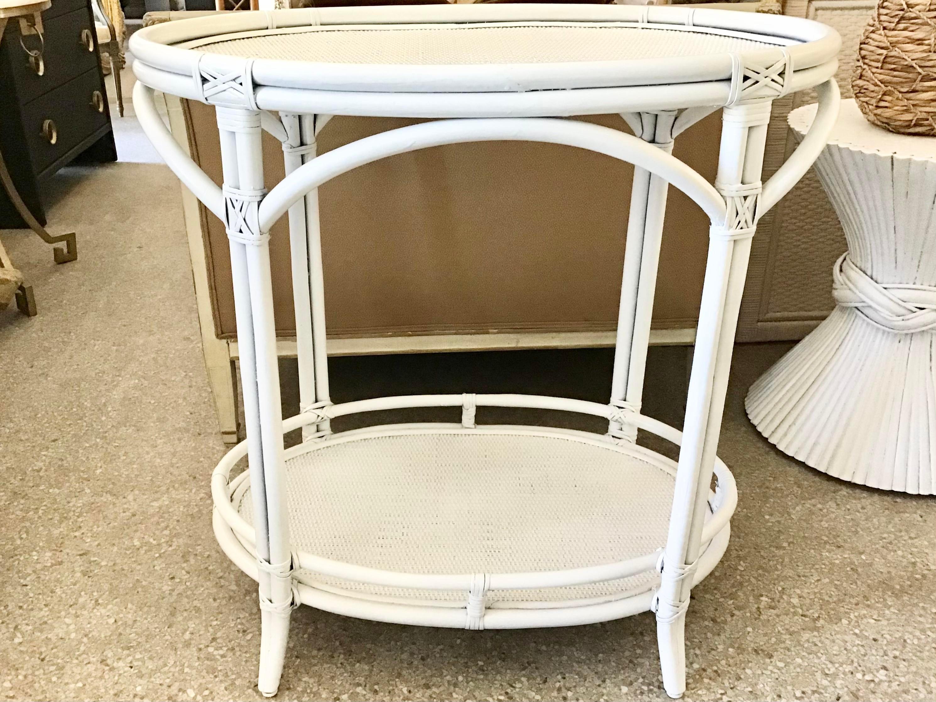 White Boho Chic oval top rattan bar table. Entertain your guests with cocktails with this serve table at your bar. Fresh white lacquer finish!