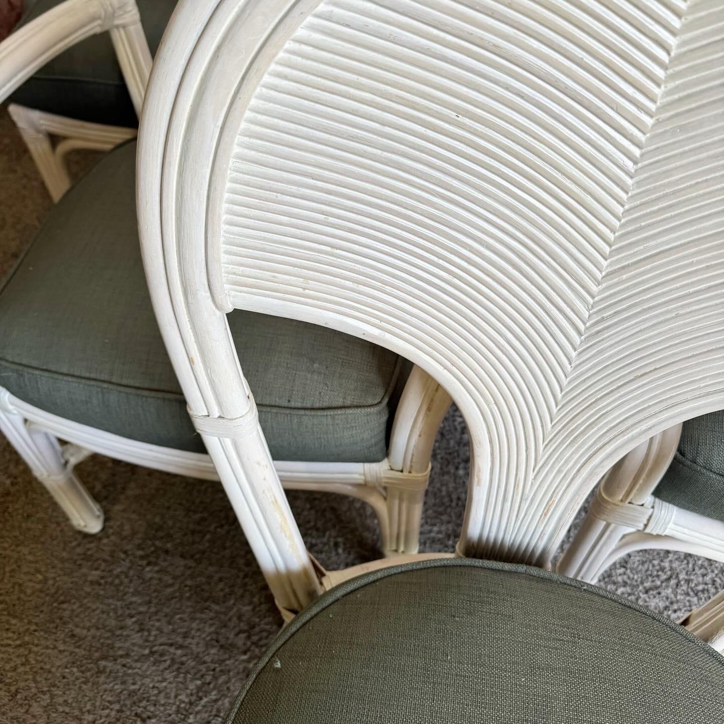 Bring boho chic style to your dining space with this set of 6 pencil reed and rattan dining chairs. Featuring sturdy rattan frames and comfortable neutral fabric seats, these chairs combine elegant curves and natural materials for a relaxed and