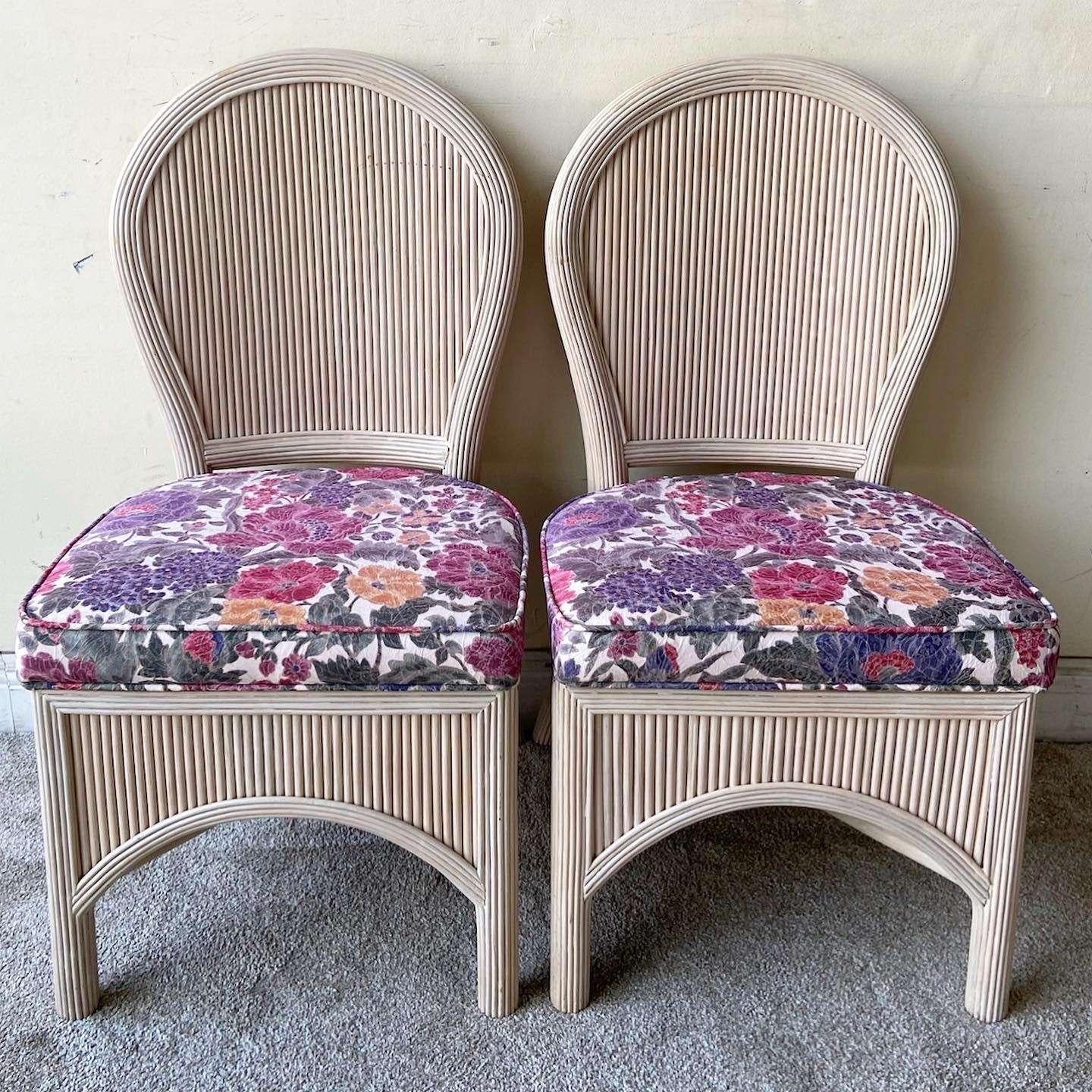 Exceptional set of 4 pencil reed dining chairs. Each feature purple floral seat cushion with a partially skirted pencil reed base.

Seat height is 18.0 in