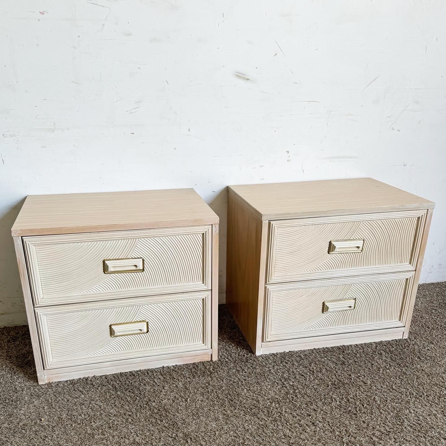 Introduce a touch of Boho chic elegance to your bedroom with these Henry Link Pencil Reed Nightstands by Lexington. Crafted in the 1980s, they feature a unique pencil reed design and two spacious drawers with stylish brass handles. The light,