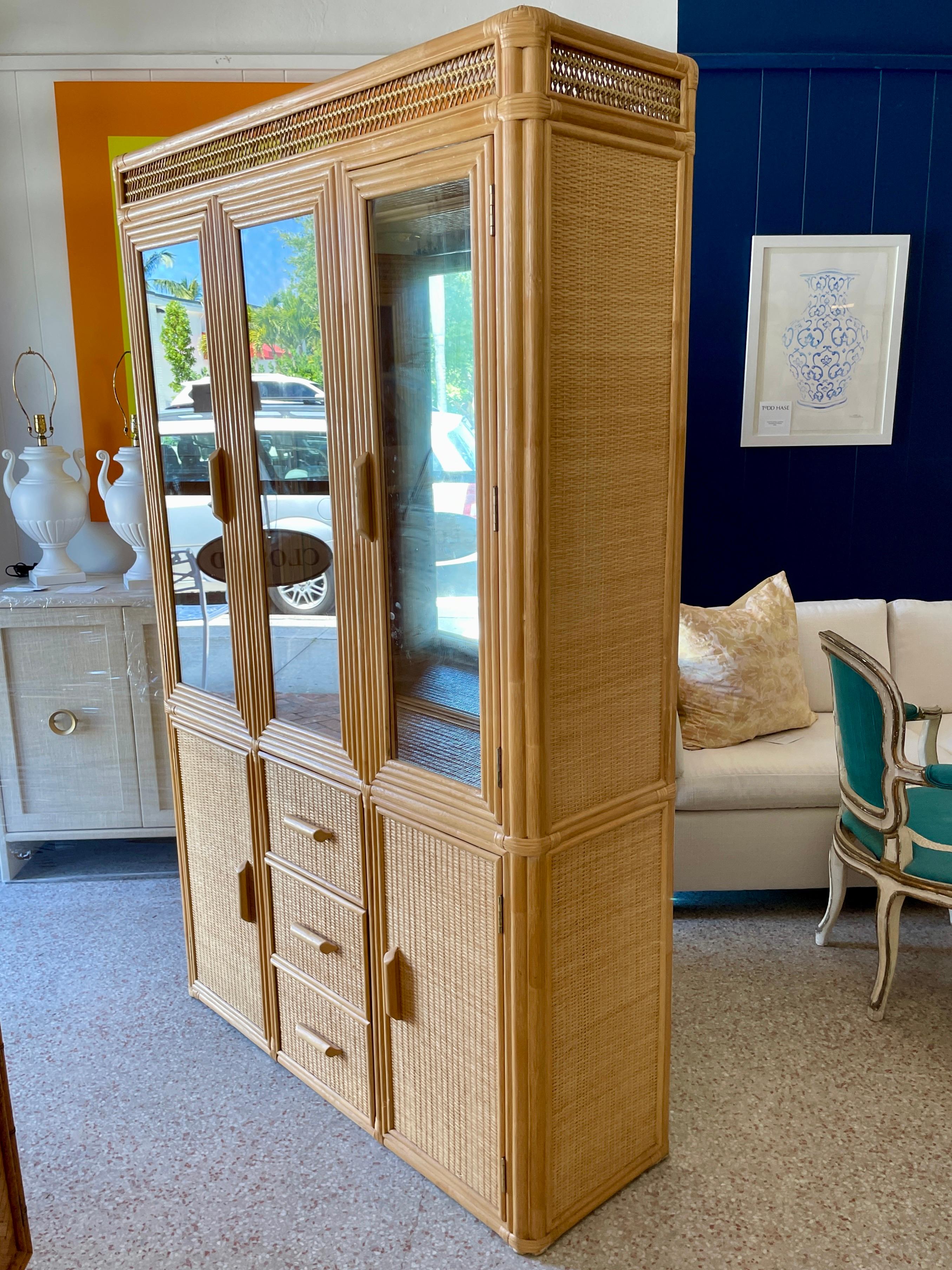 Beautiful boho chic raffia and rattan display cabinet with top glass doors and mirrors, and bottom drawers and doors for storage. Great addition to your boho chic inspired kitchen and dining area.