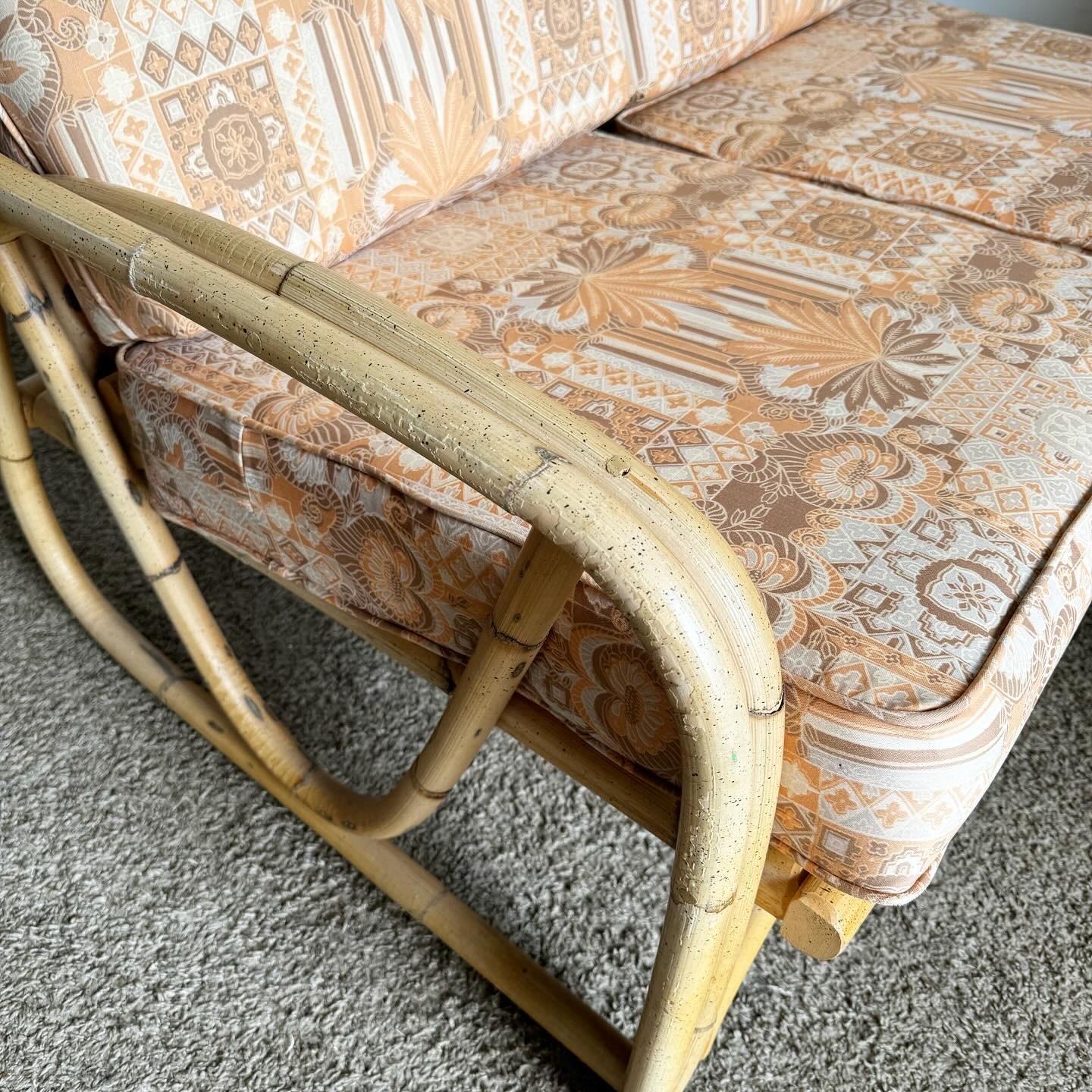 Boho Chic Sculpted Bamboo Rattan Loveseat With Patterned Tufted Cushions In Good Condition For Sale In Delray Beach, FL