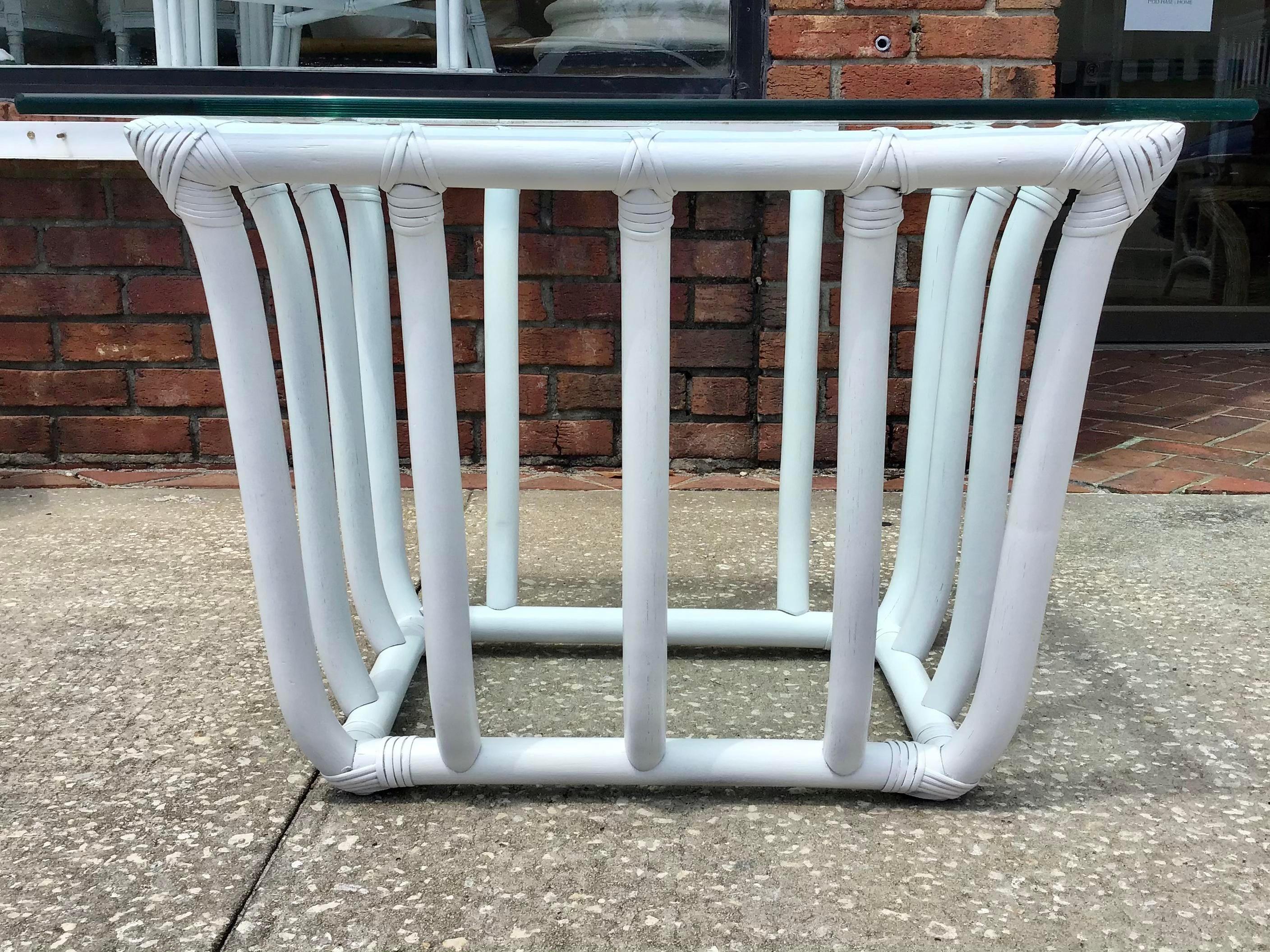 Fun Boho Chic rattan rectangular side table freshly lacquered in white with a glass top. Add it to your chic home furniture collection. We have additional tables in the same style.