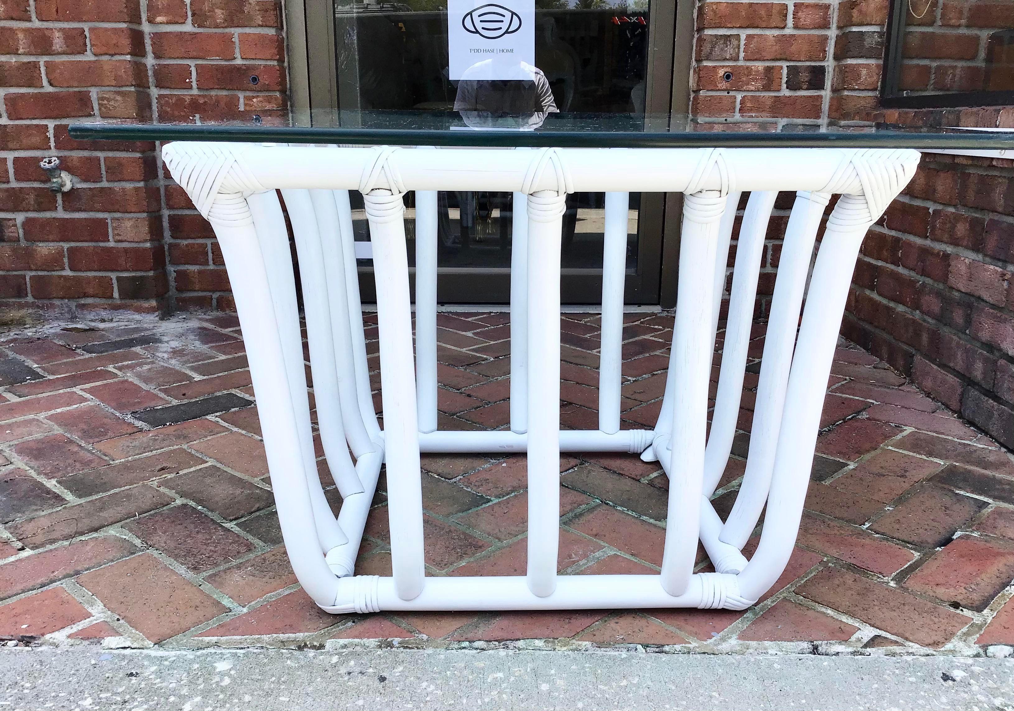 Freshly lacquered in white boho chic rattan side Table table in white with a glass top. Add to your chic home furniture collection. We have additional tables in this same style and finish.