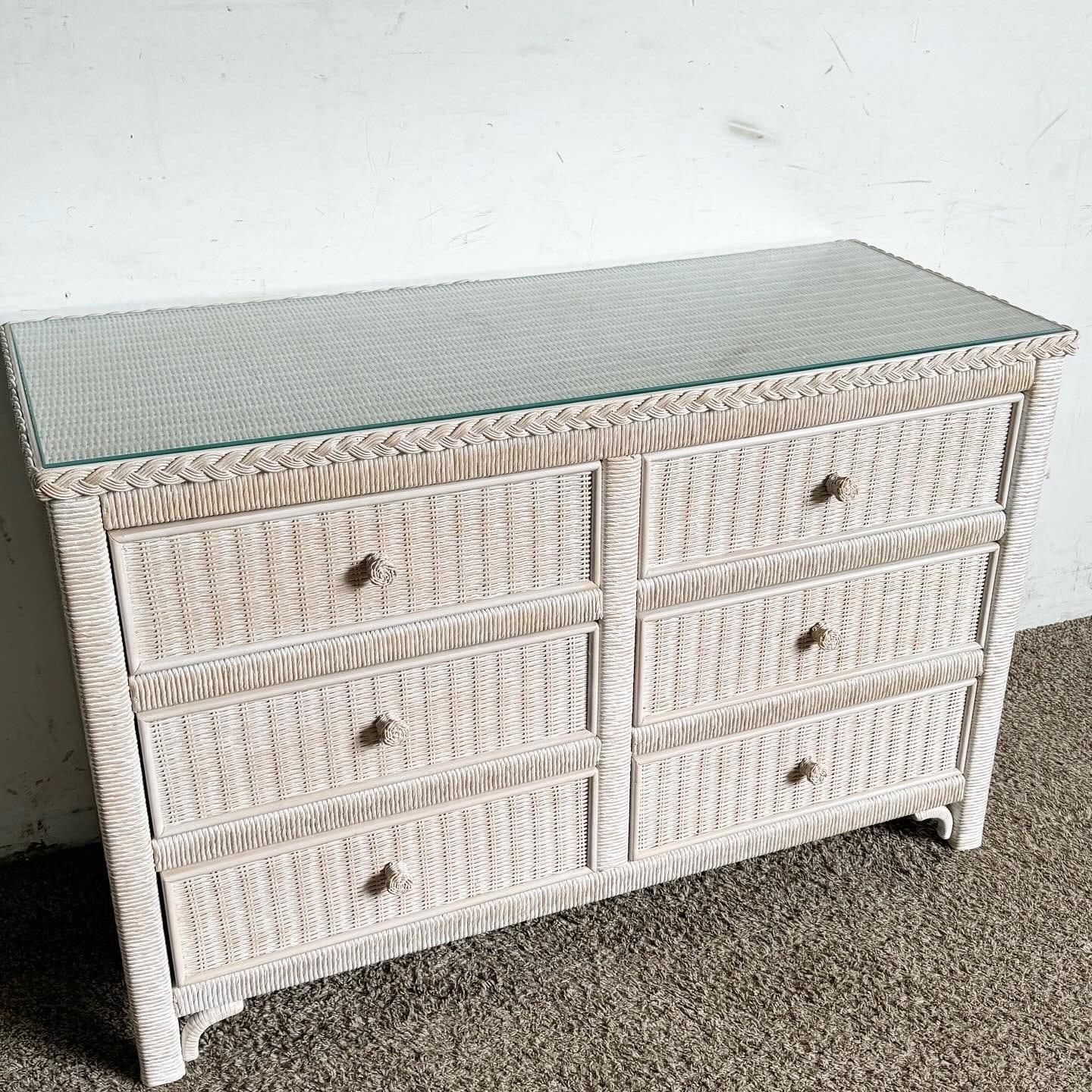 This stunning Boho Chic Wicker Dresser by Henry Link, crafted by Lexington Furniture, combines style and practicality. Featuring six spacious drawers and a sleek glass top, it offers ample storage while enhancing your room's decor. Ideal for vintage