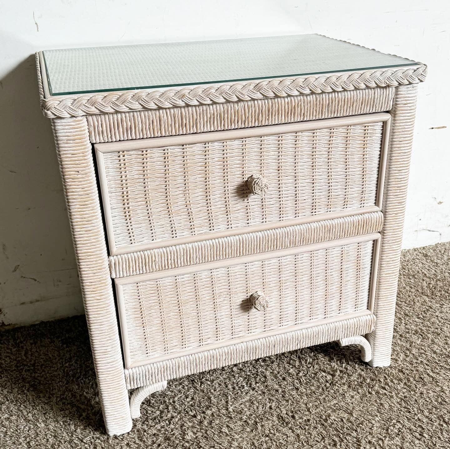 Enhance your bedroom decor with the Boho Chic Wicker Nightstand by Henry Link, crafted by Lexington Furniture. Featuring two spacious drawers and a glass top, this white washed piece combines functionality with timeless elegance. Perfect for vintage