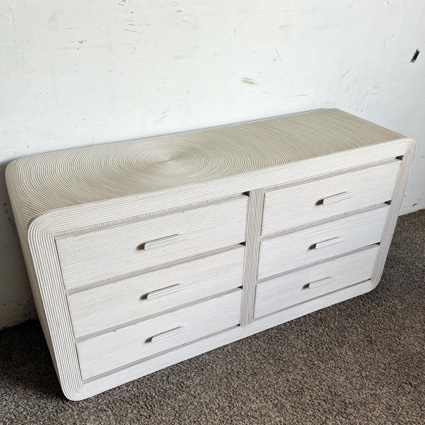 Enhance your home decor with the serene beauty of this Boho Chic White Washed Swirl Pencil Reed Waterfall Dresser. Crafted with exquisite attention to detail, this dresser features a captivating swirl pencil reed design and a relaxed white washed