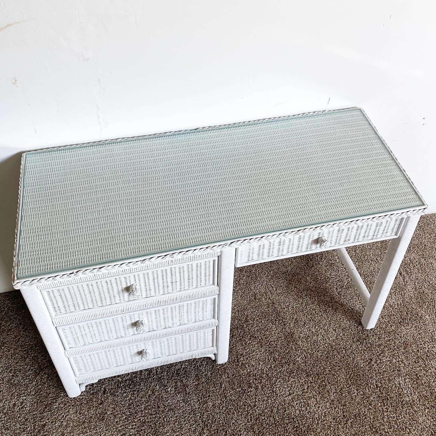 Exceptional vintage, bohemian wicker, and rattan writing desk by Henry Link. Features a painted white finish with a rectangular inlaid glass top.