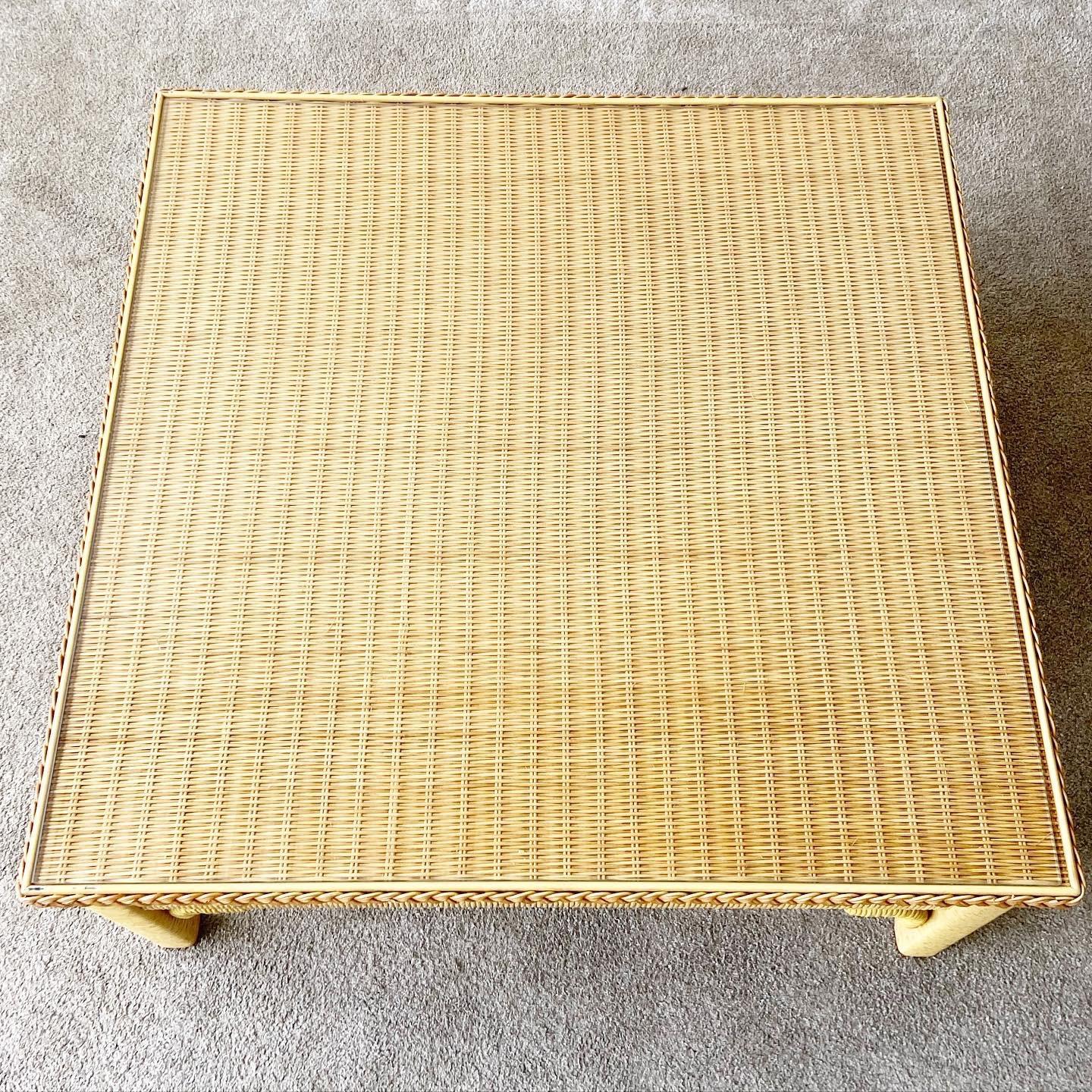 Exceptional bohemian coffee table by Henry link. Table features woven wicker and rattan frame with a glass top. There are no marks which read Henry Link on this table. 