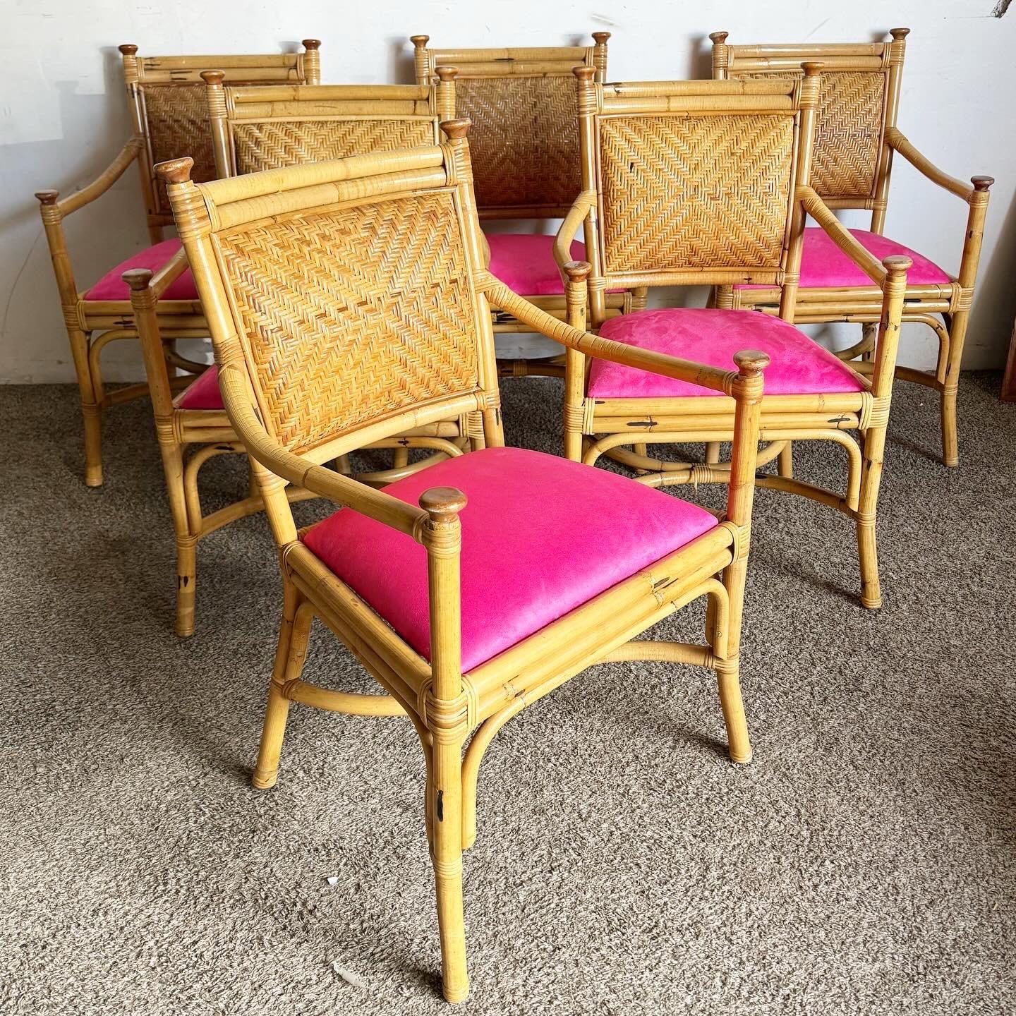 This set of six Boho Chic Dining Arm Chairs features a natural wicker, rattan, and bamboo build, accented with hot pink cushions. Perfect for adding a vibrant touch to your dining space, these chairs blend bohemian style with comfort and a pop of