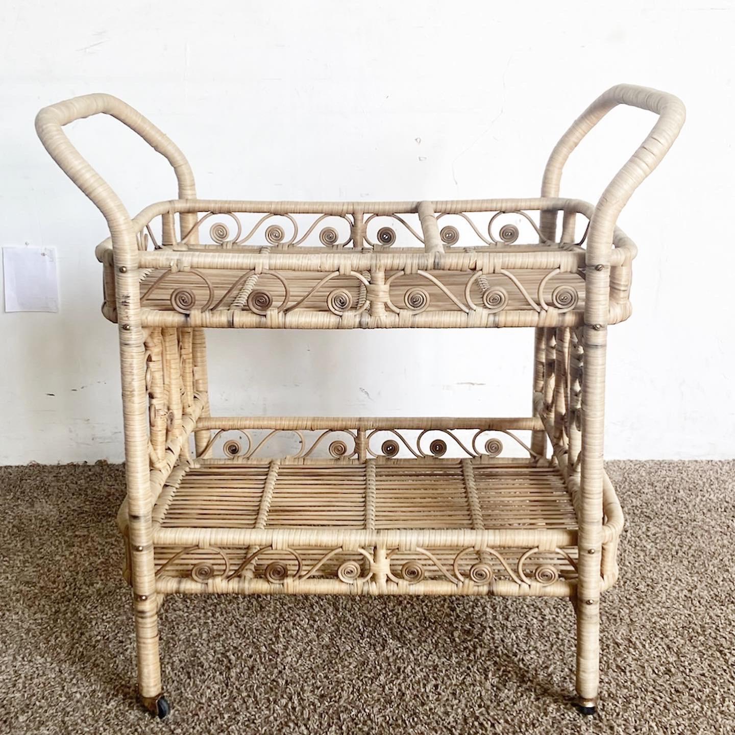 Elevate your living space with the Boho Chic Rattan Bar Cart. Designed with intricate swirls and hearts, this two-tier cart is a functional work of art.
Some wear around the edges and surfaces and wheels as seen in the photos.