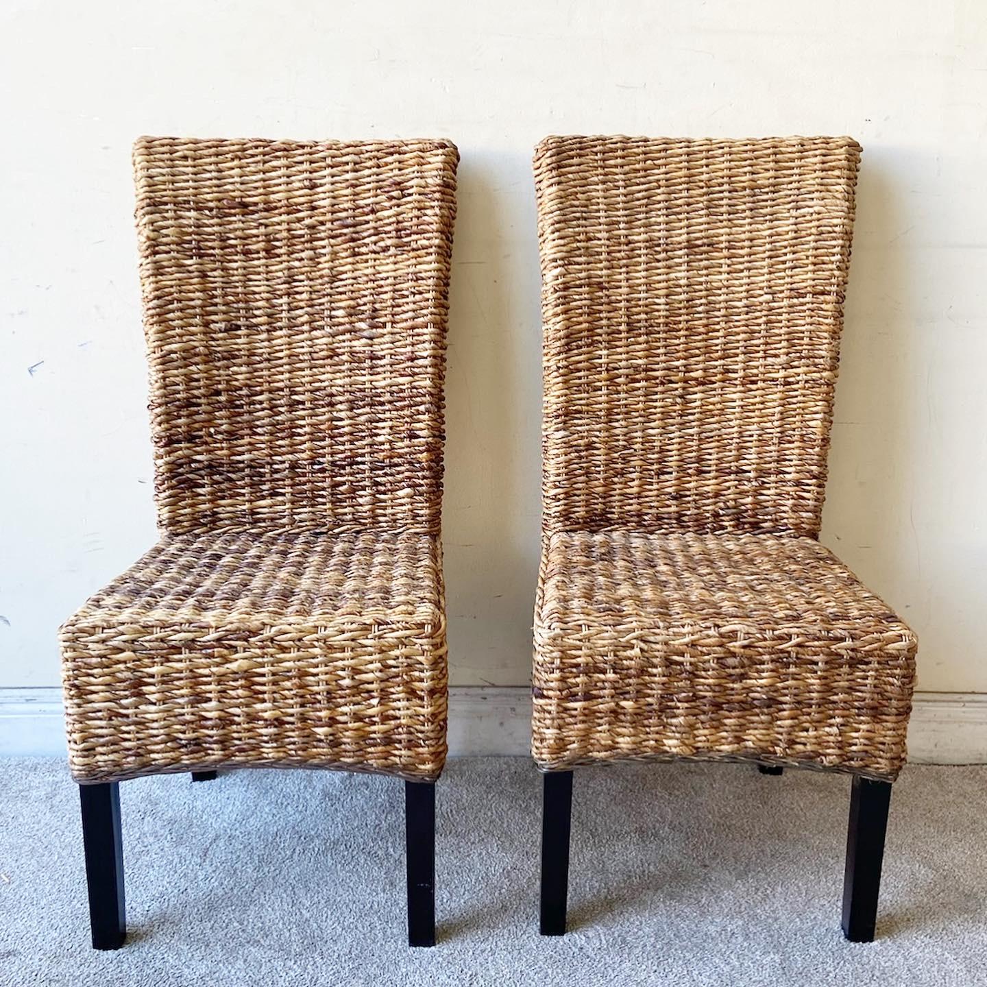 Incredible set of 4 boho chic dining chairs. Each feature a woven sea grass backrest, seat and skirt over wooden legs.