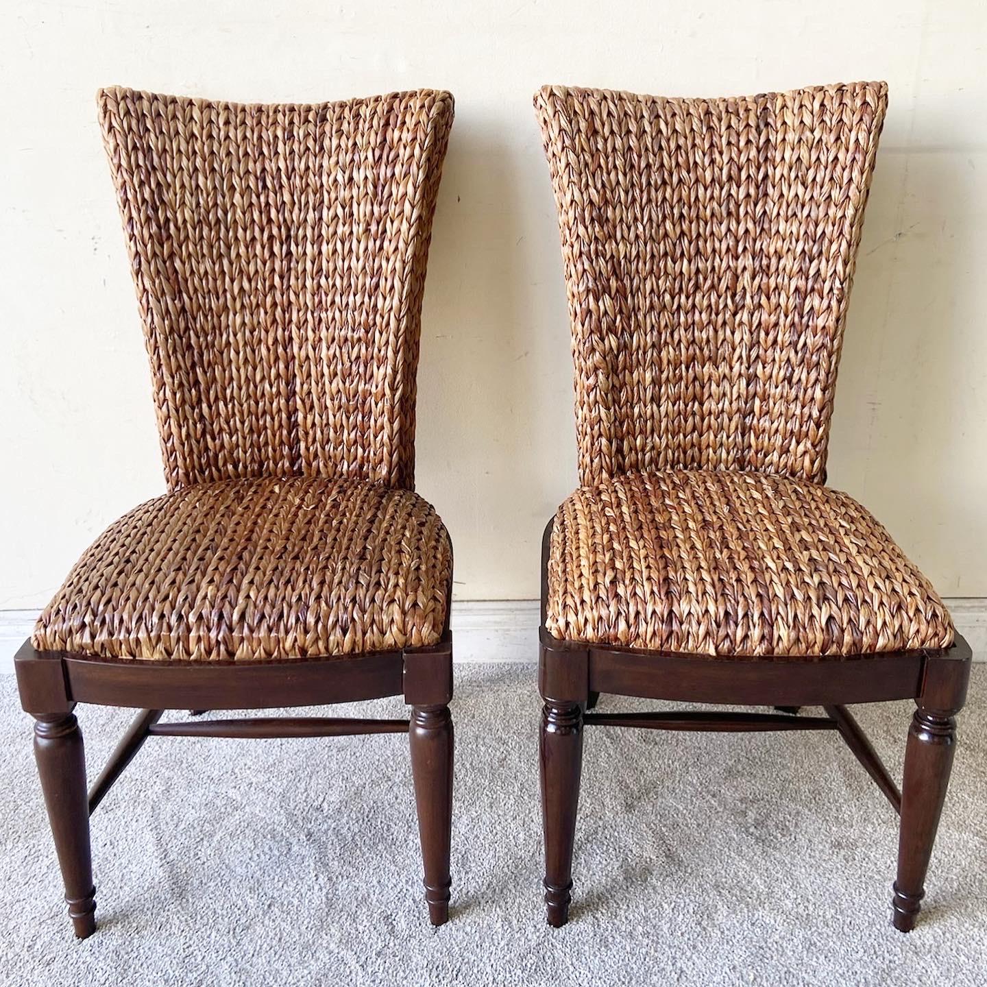 Exceptional set of 4 vintage boho chic dining chairs. Each feature a traditional wooden base with a woven sea grass back rest an seat.
