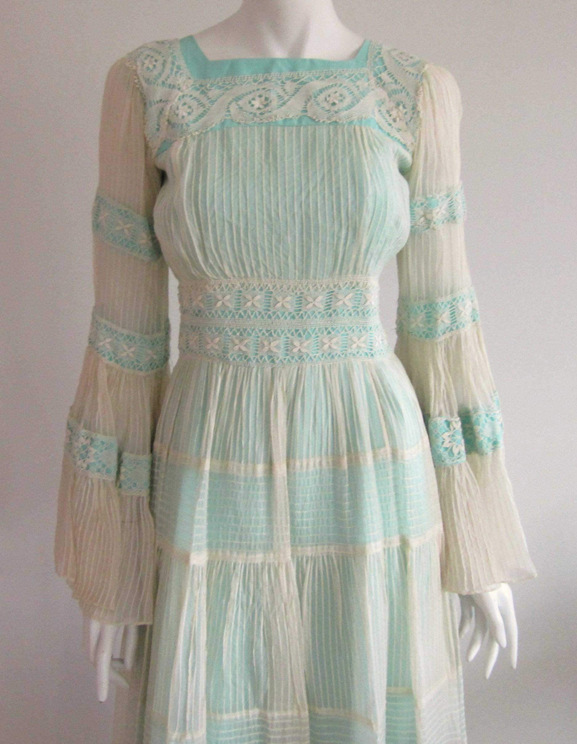 Boho Maxi Dress, with amazing bells sleeves! Lined with a blueish green lining with a cream overlay. Great for upcoming music festivals, parties and more! APPROXIMATE MEASUREMENT GARMENT MEASURED LAYING FLAT-  bust: 34 - Waist: 26- Hips: 38- Sleeves