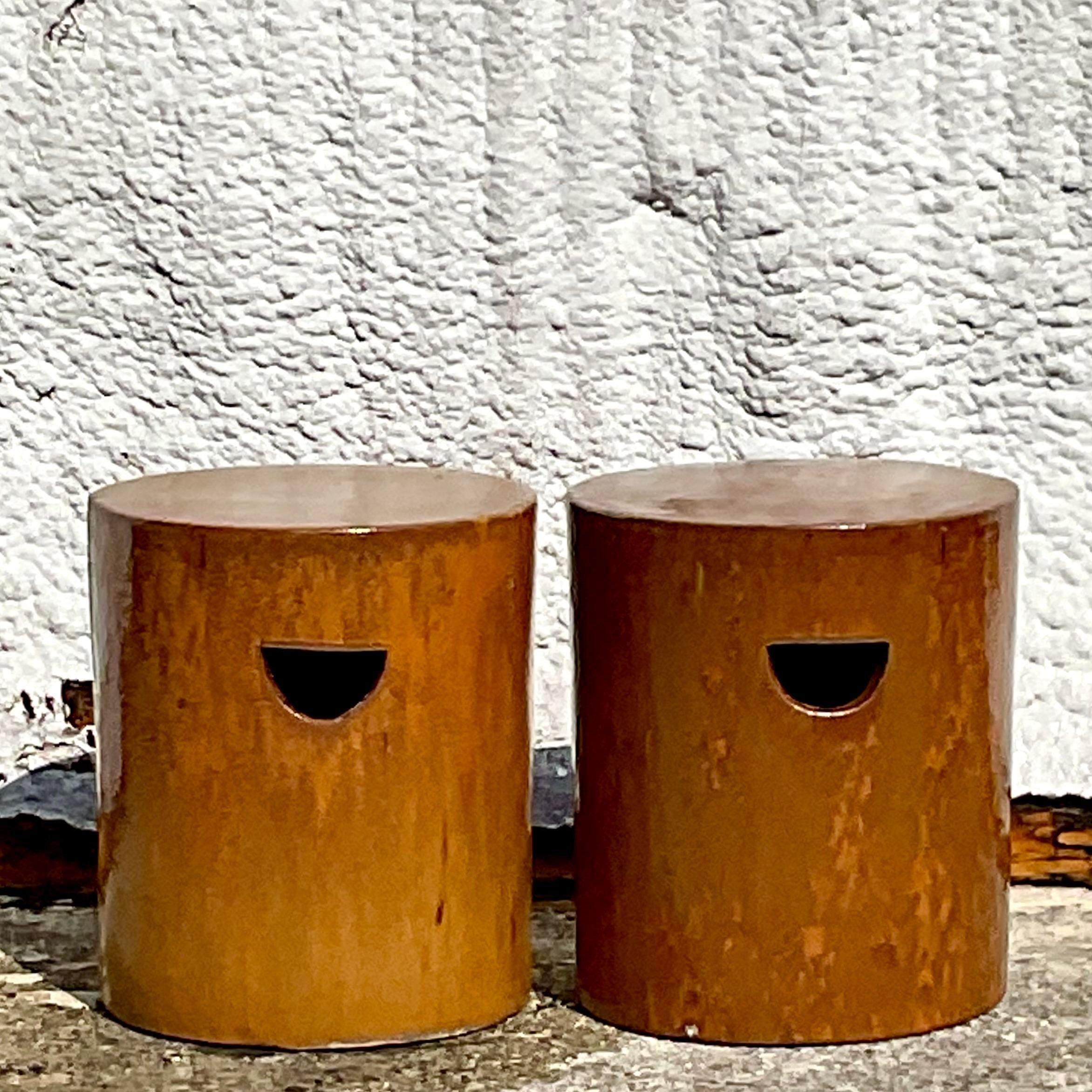 A fabulous pair of Boho low ceramic stools. A chic glazed finish in a warm orange finish. Perfect indoors or out. You decide! Acquired from a Palm Beach estate.
