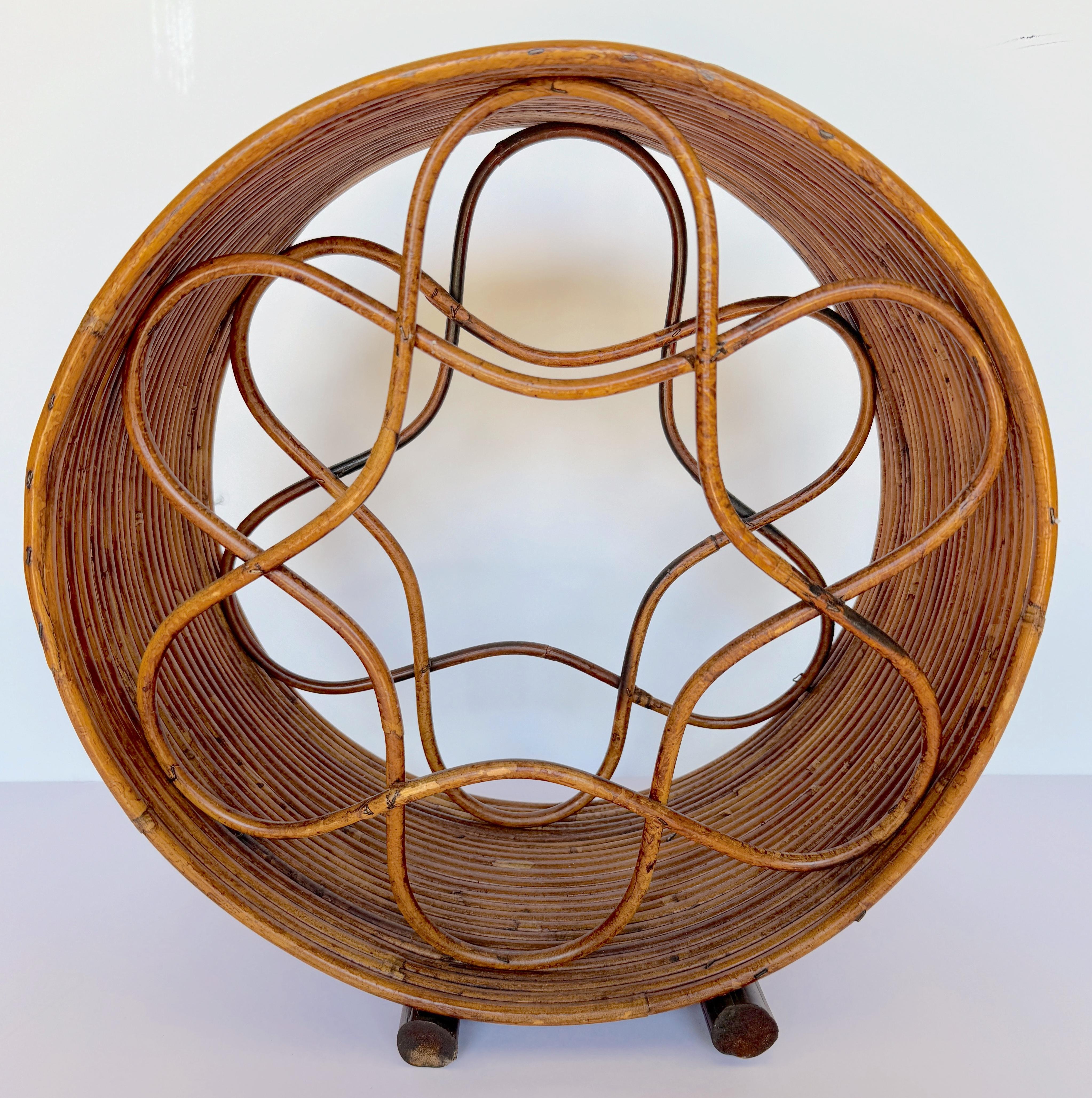 Boho Rattan Circular Porthole 6 Bottle Wine Caddy/Rack 
USA, circa 1970s 

A good-size vintage Boho Rattan Circular Porthole 6 Bottle Wine Caddy/Rack from the USA, circa 1970s. This sculptural and functional piece stands 16 inches high, 15.5 inches