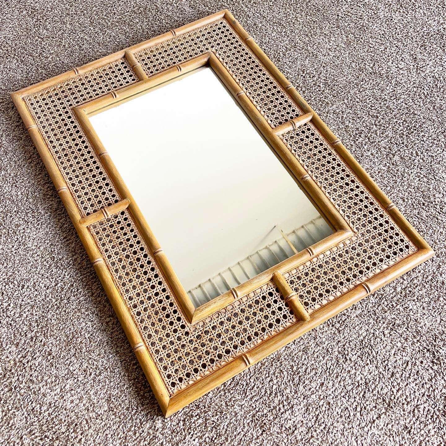 Elevate your space with the captivating fusion of boho and regency styles in this vintage Indian mirror. Crafted with a remarkable faux bamboo and cane frame, this mirror effortlessly combines non-native flair with timeless elegance, making it a
