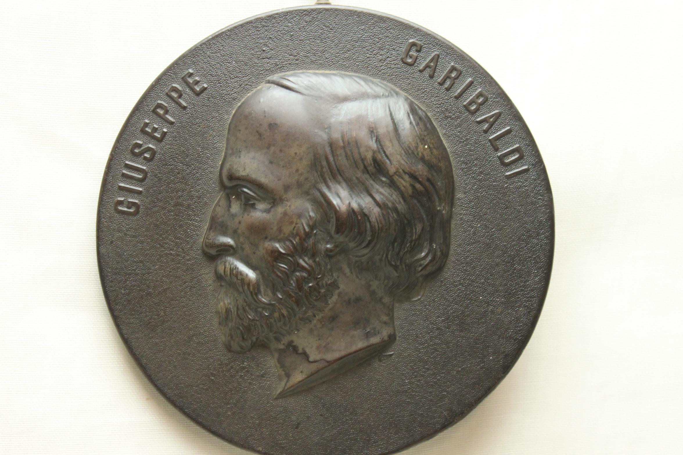 This Bois durci plaque depicts Giuseppe Garibaldi (1807-82), who is well known as a general, a revolutionary and one of the founders of modern Italy. It is from a series of ornamental plaques depicting well known figures from royalty, politics and