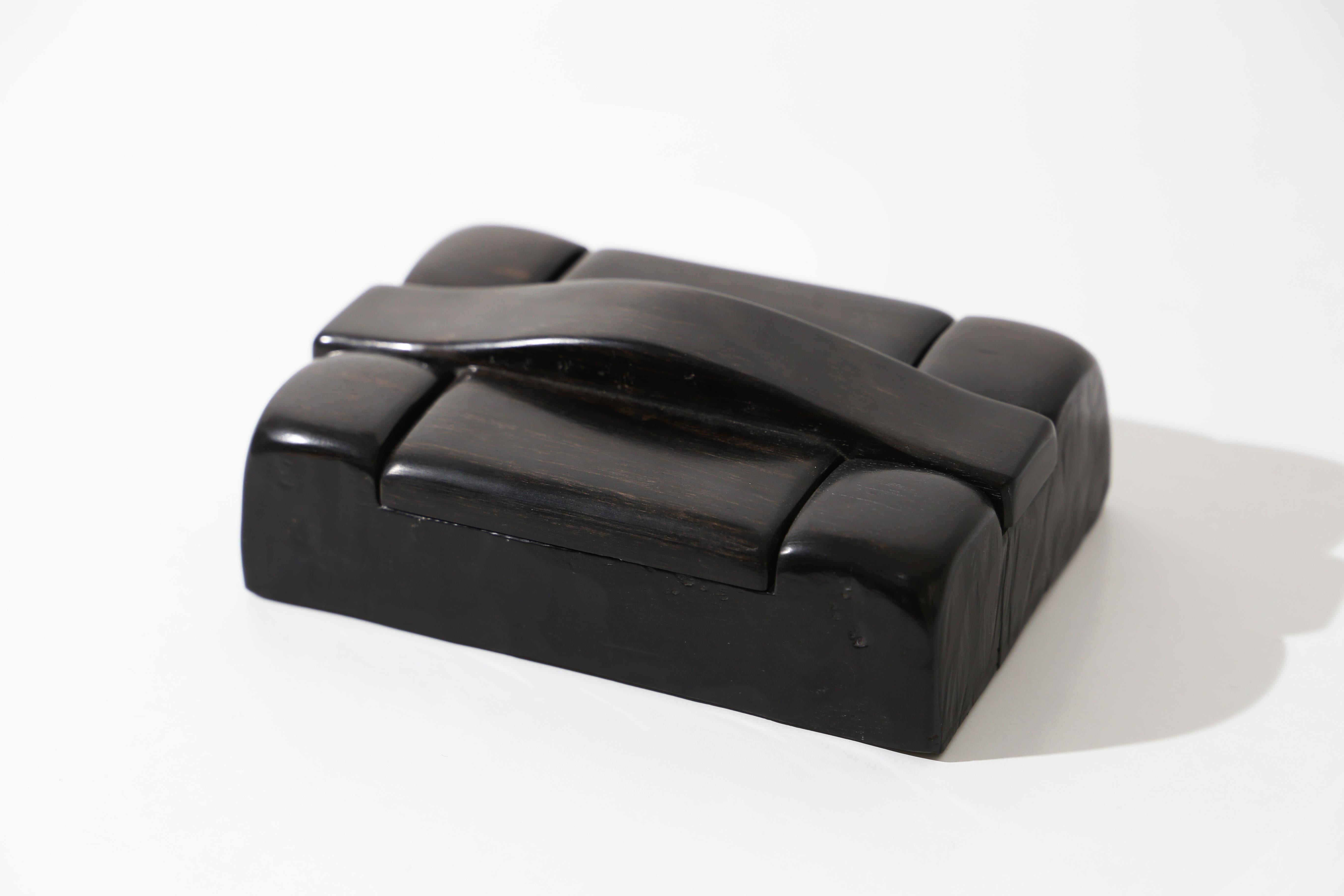 Carved box in solid Macassar ebony. It is opened by means of a handle that is also carved. It is signed 