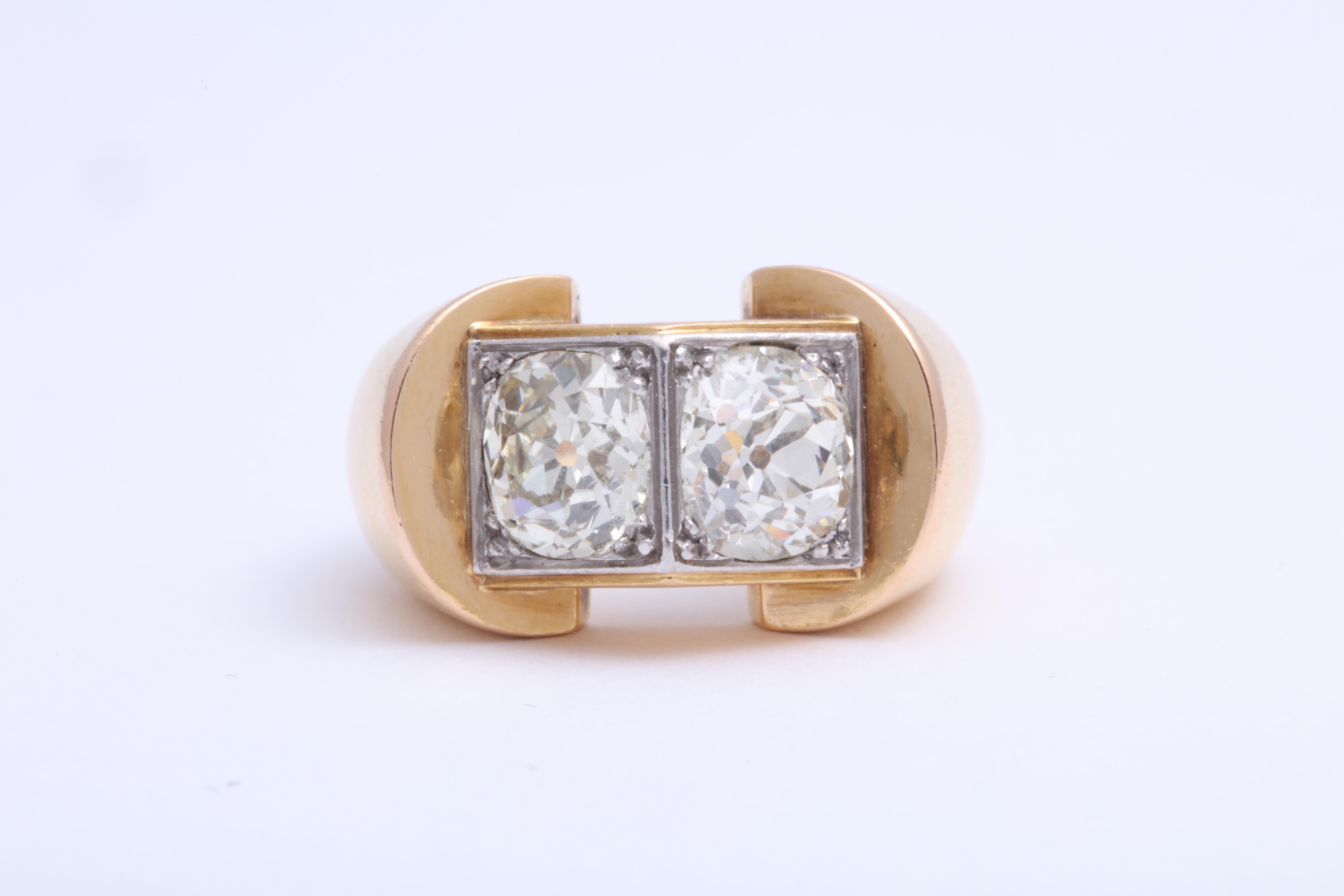 Dating to around 1940, this French 18K white gold over yellow gold cocktail ring is set with two old mine cut diamonds. Made by Rene Boivin. 