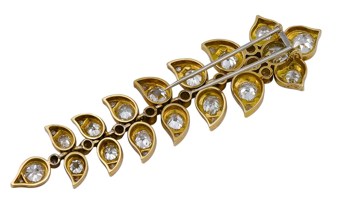 You'll notice immediately the dramatic verticality of this brooch and how its intricate construction enables it to move with you and catch the light. The diamonds are gem-quality white stones, bright and lively. We suggest you style it with a modern