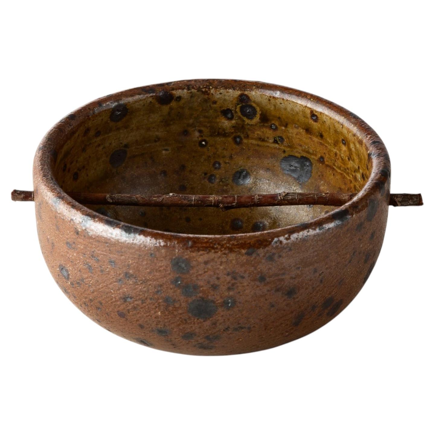 Bol percé d'une tige de bois For Sale