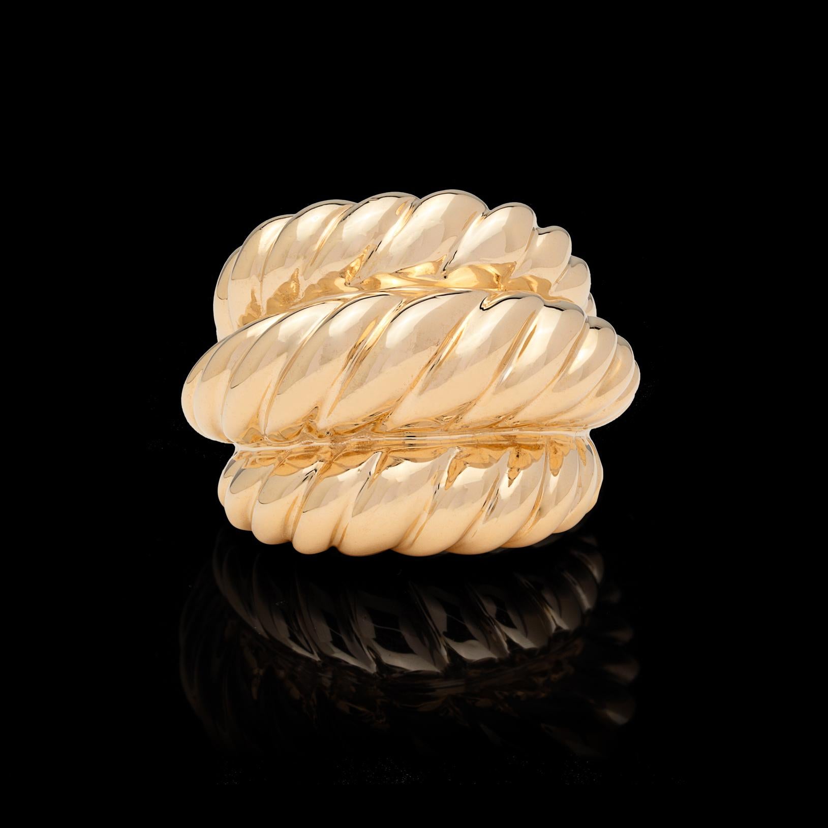 Make a statement with this 1970's 14k gold domed ring. Designed with three rows of fluted gold, this ring will quickly become a favorite. It weighs 32.51 grams, and is currently size 6 1/2 (with easy adjustment up or down). Fun and fantastic.