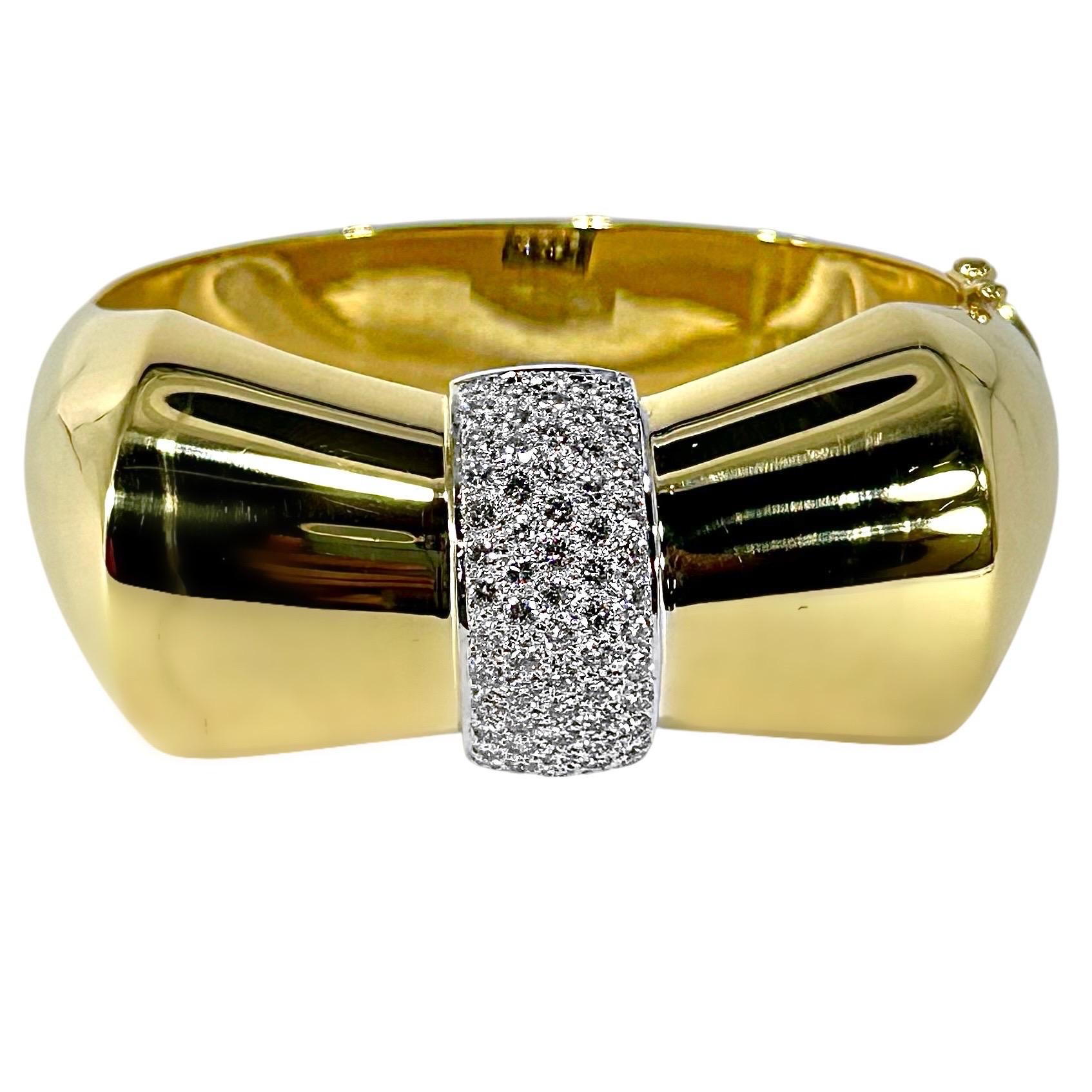 This alluring, highly stylized Mid-20th Century Retro cuff bracelet, is designed in the fashion of a large bow-tie. The center diamond encrusted cinch is visually impactful. With a design area measuring over 2 1/4 inches by 1 3/16 inches there is