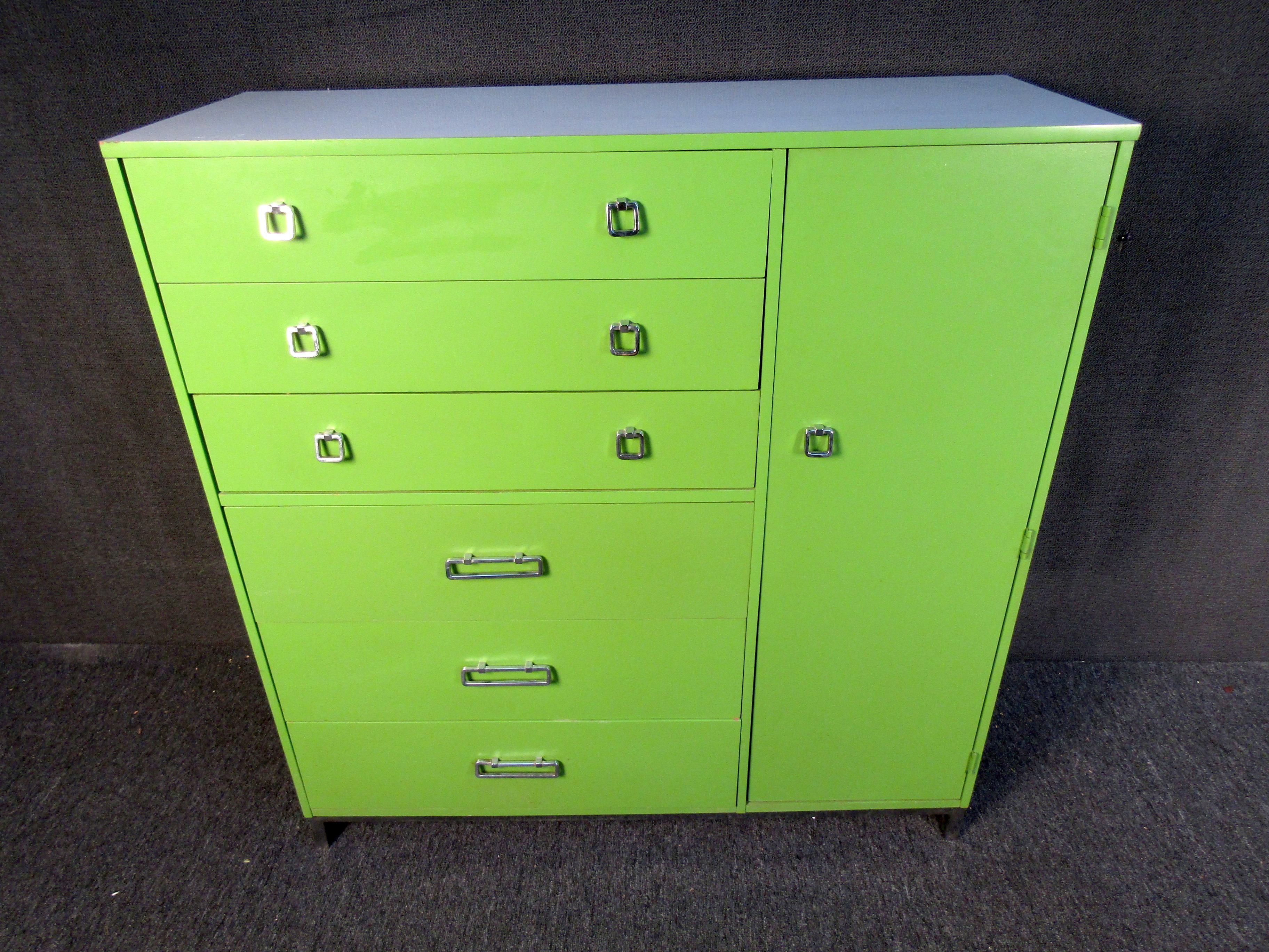 A tall designer dresser that will turn heads with its electric hue of green paint, this 80's designer piece offers plenty of storage with an eclectic design. Chrome drawer pulls compliment the dresser's color and make this dresser truly unique and
