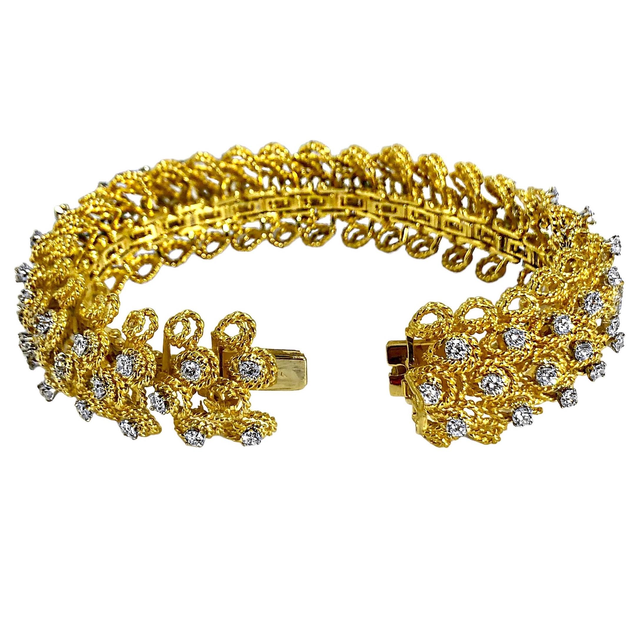 This bold and wonderful 18K yellow gold and diamond bombe bracelet is pure American in style. Every link is composed of multi level tear drop shaped links made of twisted wire, five across.  The center of the bracelet is set with three rows of
