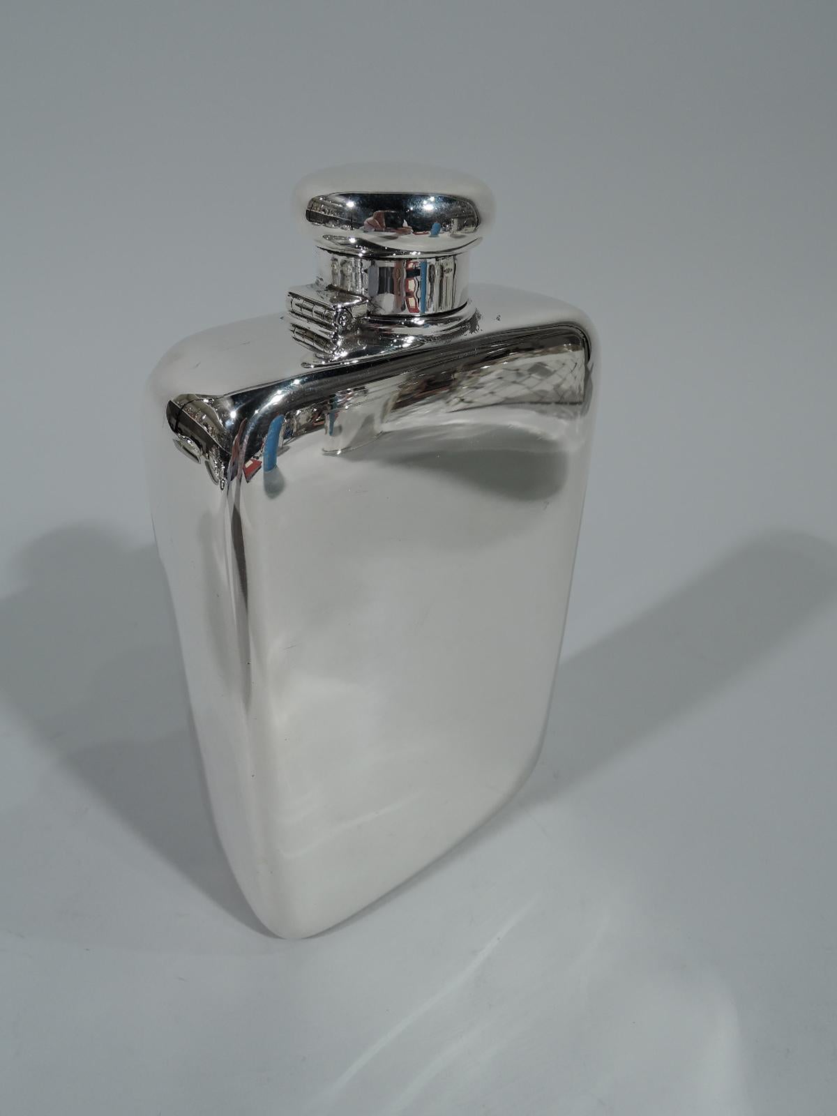 Bold and modern sterling silver flask. Made by Tiffany & Co. in New York. Quadrilateral with flat bottom and top. Short neck with hinged and cork-lined bun cover. Manly size – requires a large hand span to grip. Hallmark includes no. 18230 (first