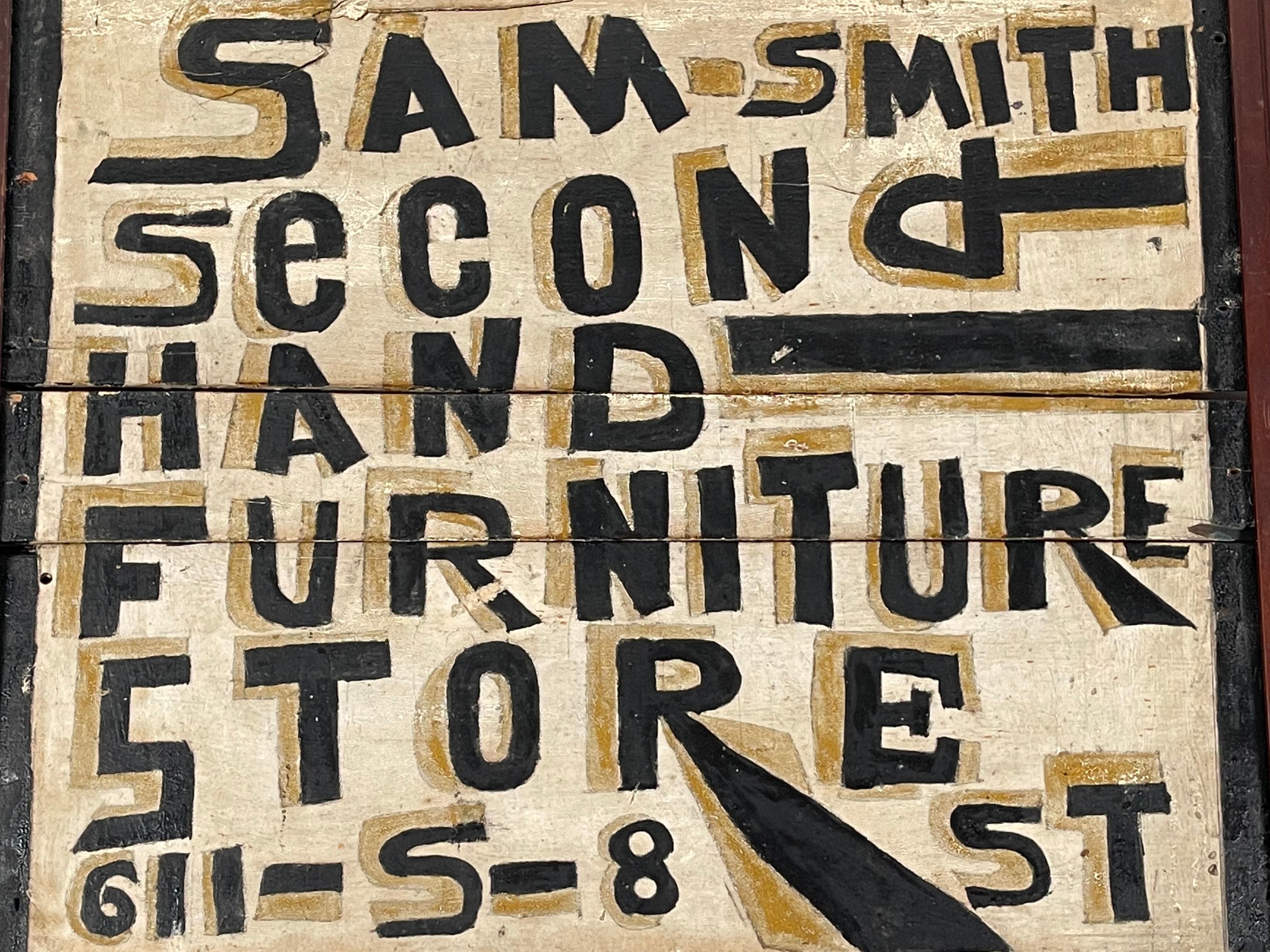 An unusual and wonderfully graphic Folk Art hand painted trade sign advertising Sam - Smith Second Hand Furniture Store. 611 S 8 St, hand painted on wood in bold black lettering with ochre-tan shadowing on a cream ground. Original paint on wood.