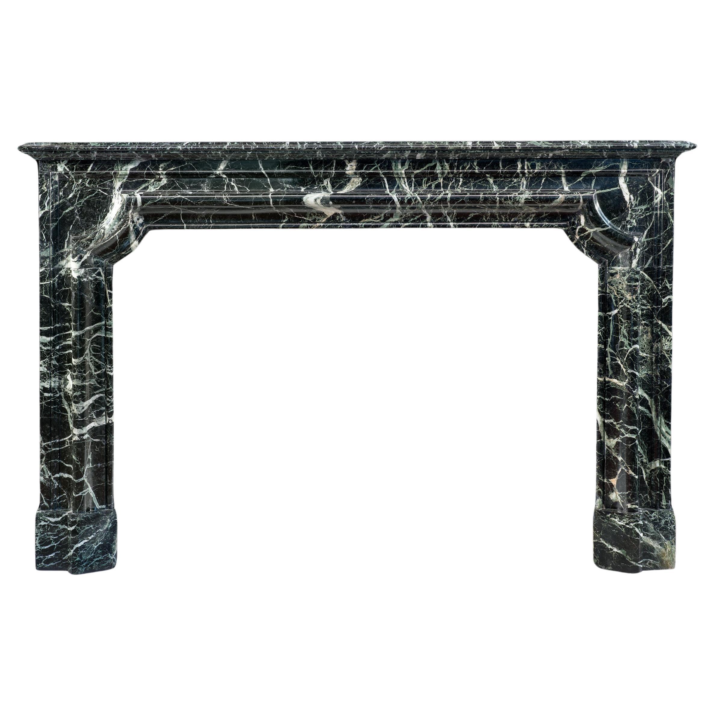 Bold Antique French Baroque Bolection Fireplace in Green Marble For Sale