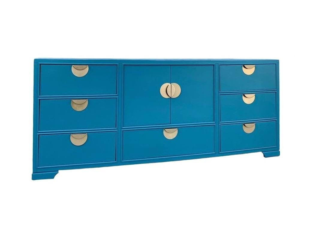 This one is a stunner! Quality piece of solid mahogany case construction meticulously restored in ocean blue lacquer. Rectangular top piece and conforming case supports seven drawers and double cabinet doors. It terminates on bracket feet. Killer
