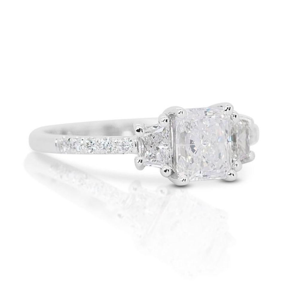 Embrace the captivating allure of this statement ring, featuring a mesmerizing 1.02 carat cut-cornered rectangular modified brilliant diamond, also known as a radiant cut diamond, as its radiant centerpiece. Graced with an exceptional E color, this