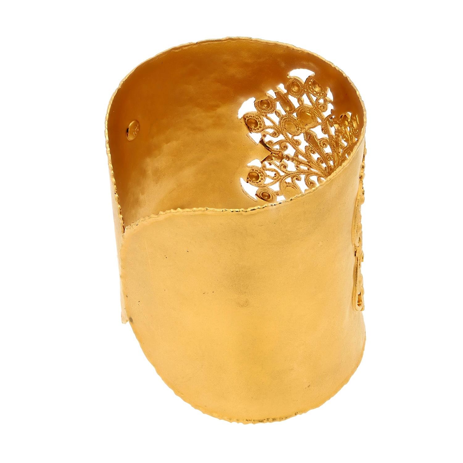 A bold Byzantine revival wide cuff bangle bracelet in an ornate pierced and hammered 14k yellow gold Etruscan design. Studded with diamonds, the rich patina displays a higher karat look due to the finishing with 18k yellow gold. A ravishing