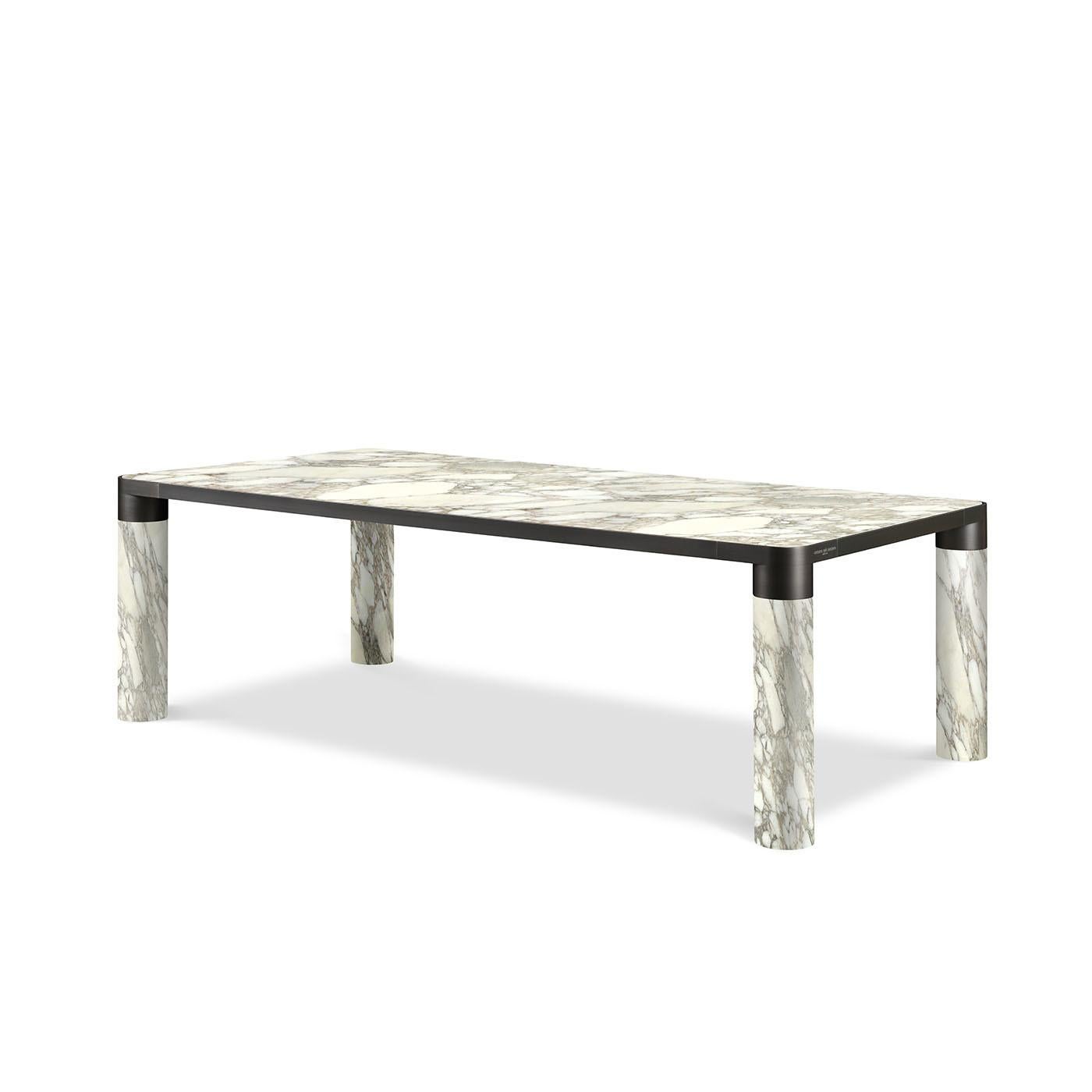 A stunning combination of noble materials and elegant hues, this dining table flaunts a minimalist and bold silhouette that will be an eye-catching focal point in a contemporary dining room. Marked by a classic rectangular shape, it features four