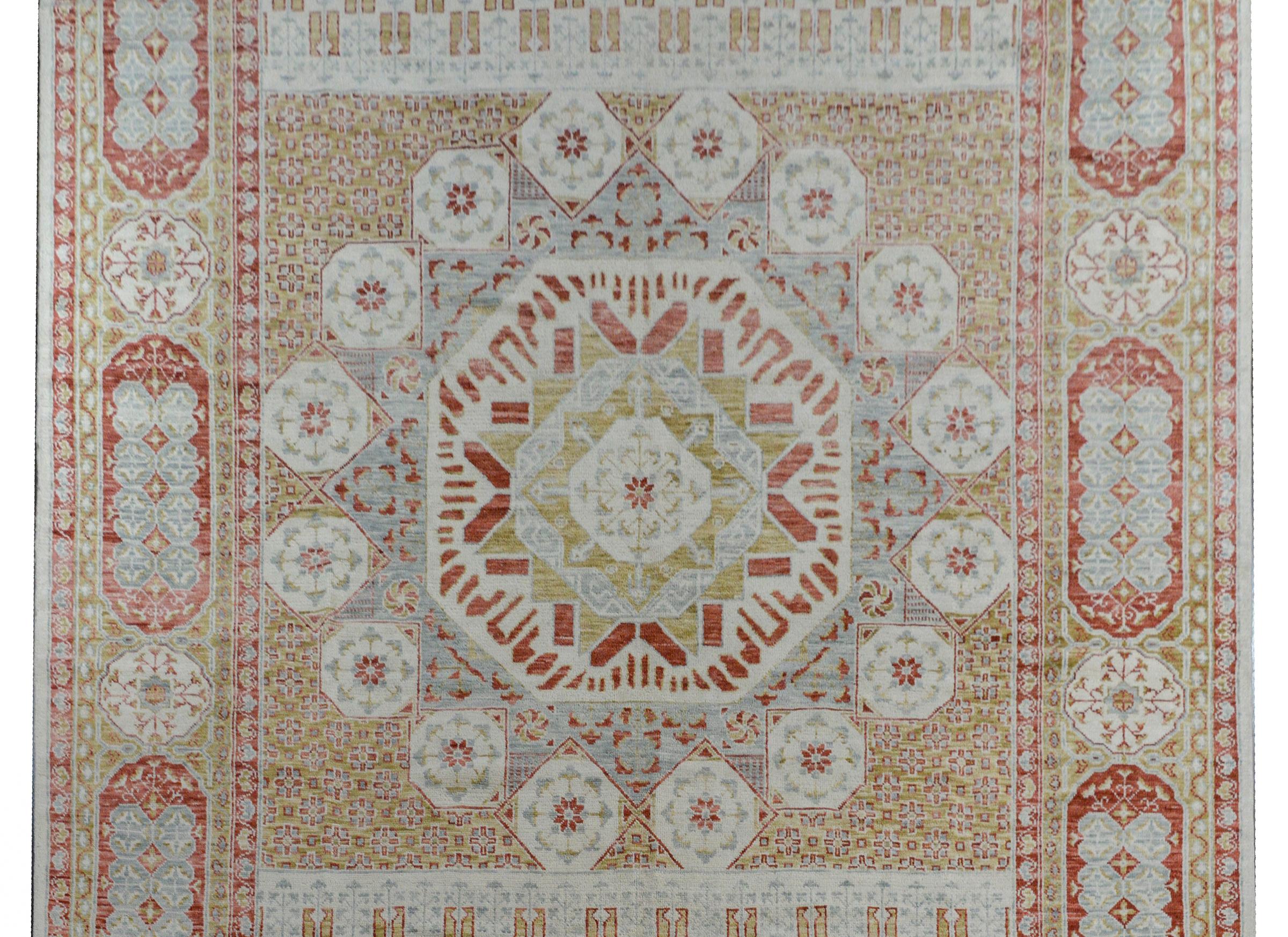 A beautiful contemporary Indian rug woven with a traditional Anatolian Turkish pattern with a large eight-sided medallion in the center amidst a field of flowers surrounded by a wide border containing myriad stylized flowers and scrolling vines.