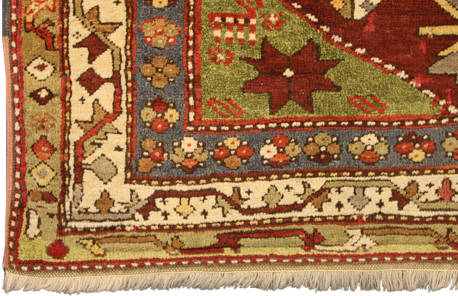 A fine Kazak rug, South Caucasus. The abrashed deep rust field with various angular floral motifs and hooked panels around double hooked octagon medallions containing hooked bars, Green stellar flower head and animal figure spandrels. In an Ivory,