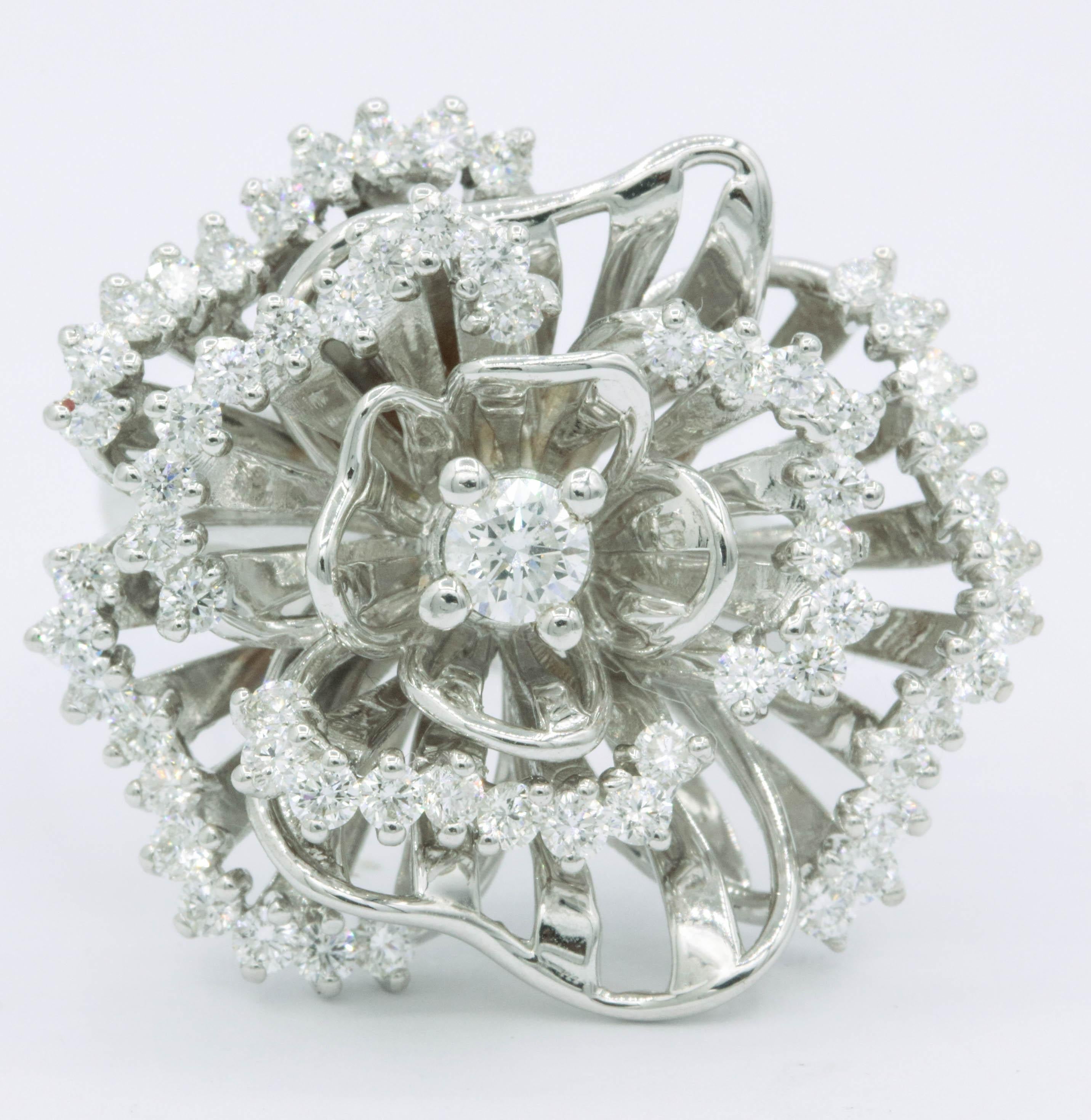 This fashionable floral ring features 63 round brilliants weighing 1.84 carats, crafted in 18k white gold. 
Center White sapphire
Color: F-G
Clarity: SI