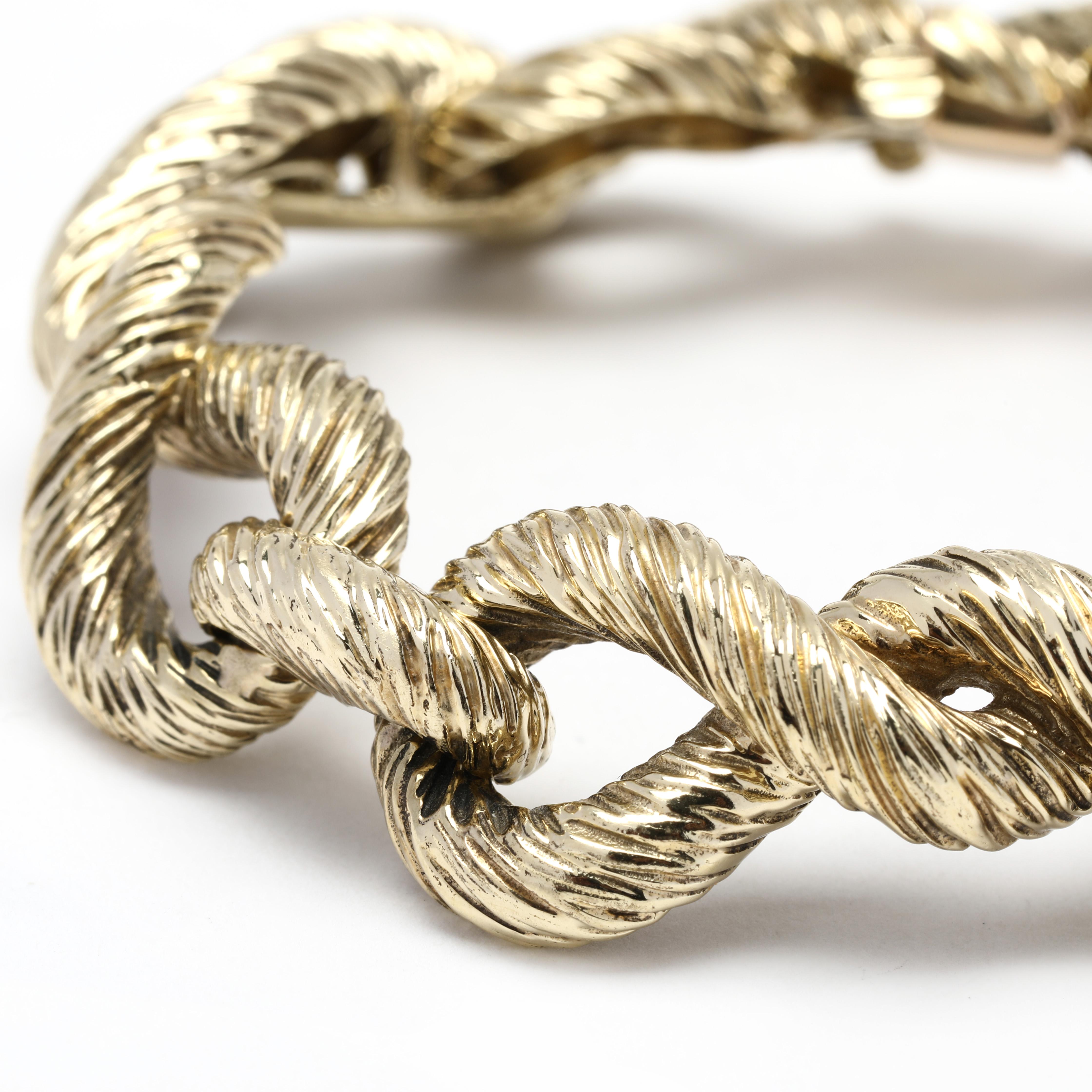 This beautiful solid 14K yellow gold figure eight link bracelet is perfect for any occasion or outfit. Accented with a textured surface that catches the light and glimmers with every move, this 7.5 inch bracelet is designed to add a modern touch to