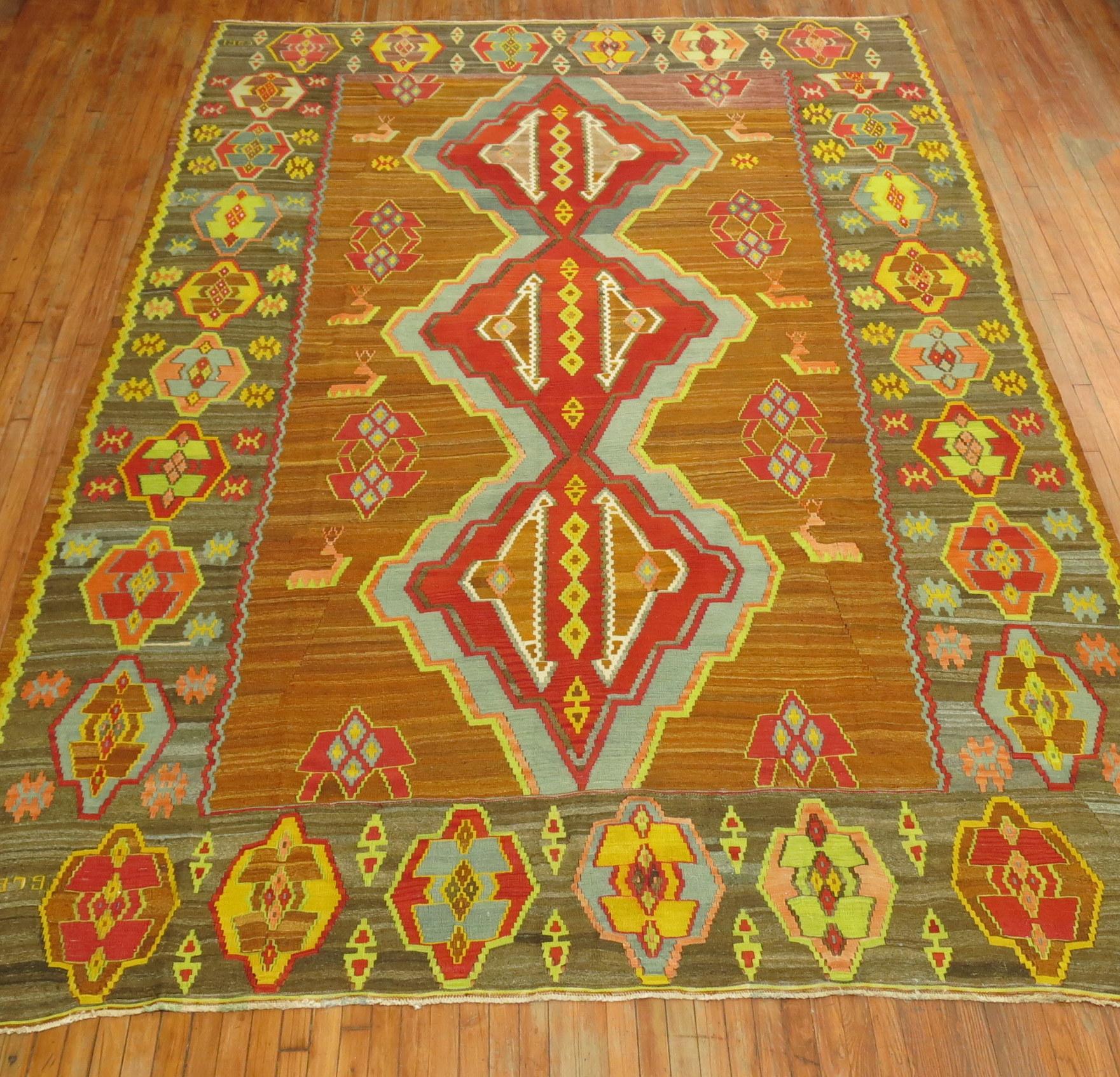 Spectacular one of a kind colorful vintage Turkish Kilim. 3 Large geometric medallions on a brown field surrounded by a bunch of deers and a crazy large tribal border. Dated 1979 on 1 border & 1980 on another end border showing the year the weaver