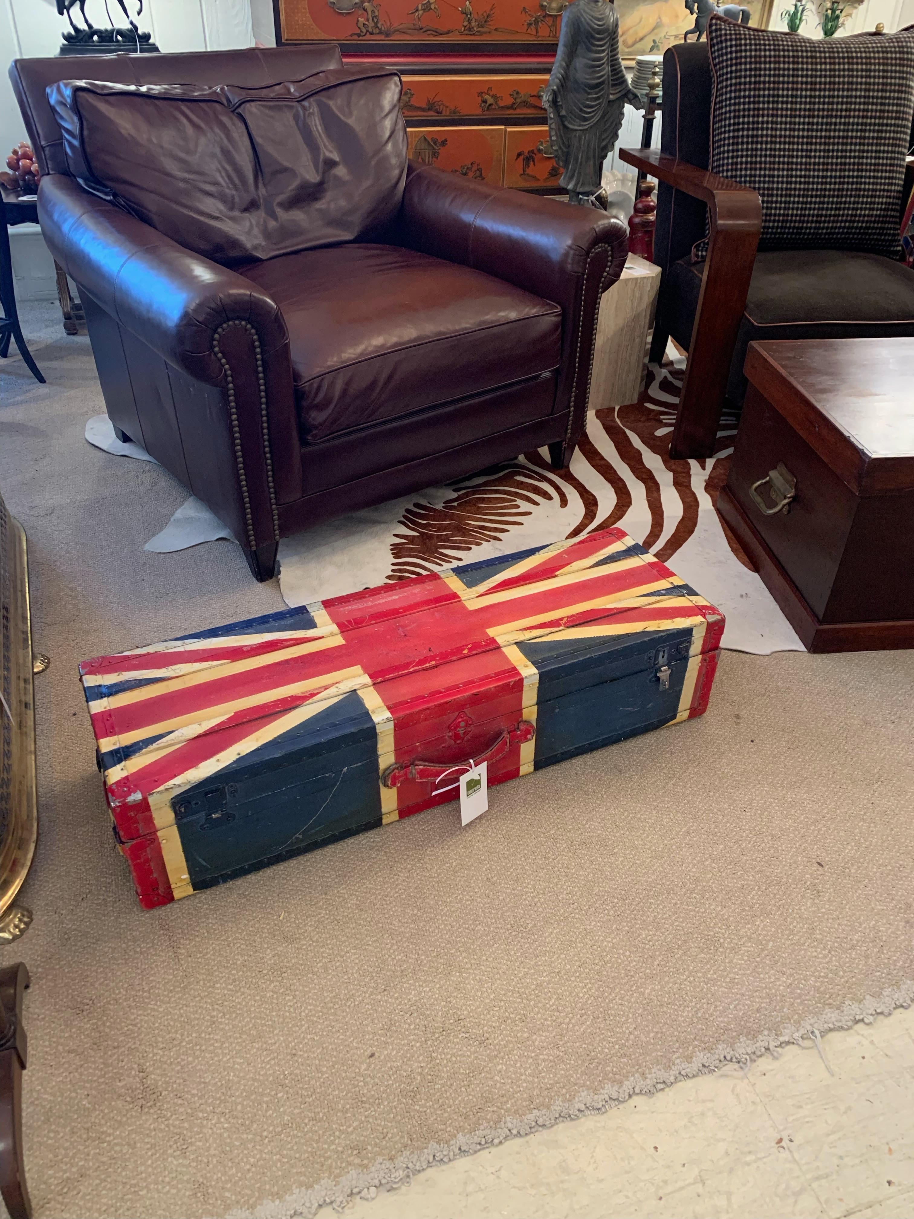 Marvelous graphic hand painted canvas British trunk decorated with a flag motife having leather corners and handle and bright green felt lined compartments.
 